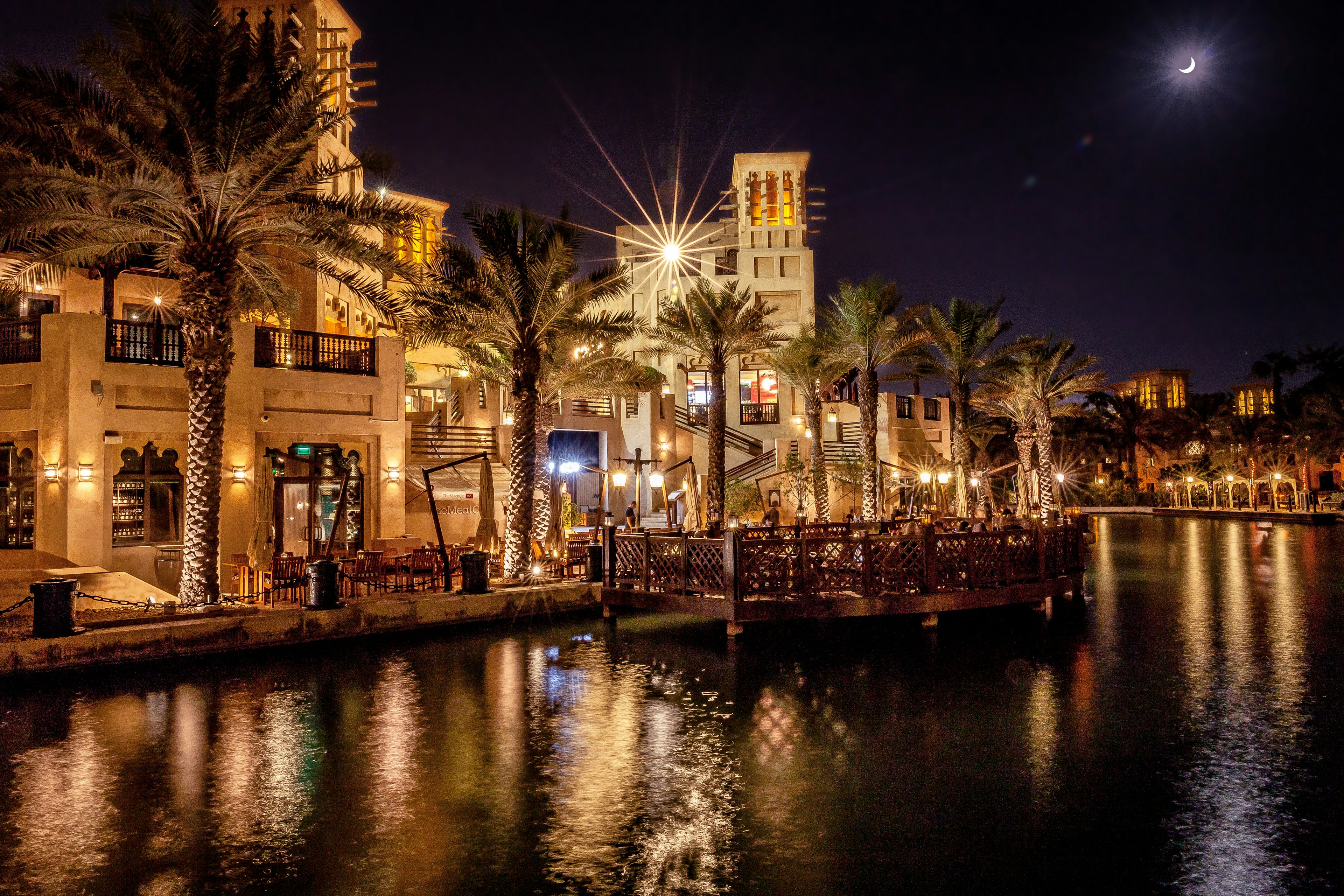 Bazaar in traditional Middle Eastern style in Dubai with stalls & restaurants under wooden covered arcade