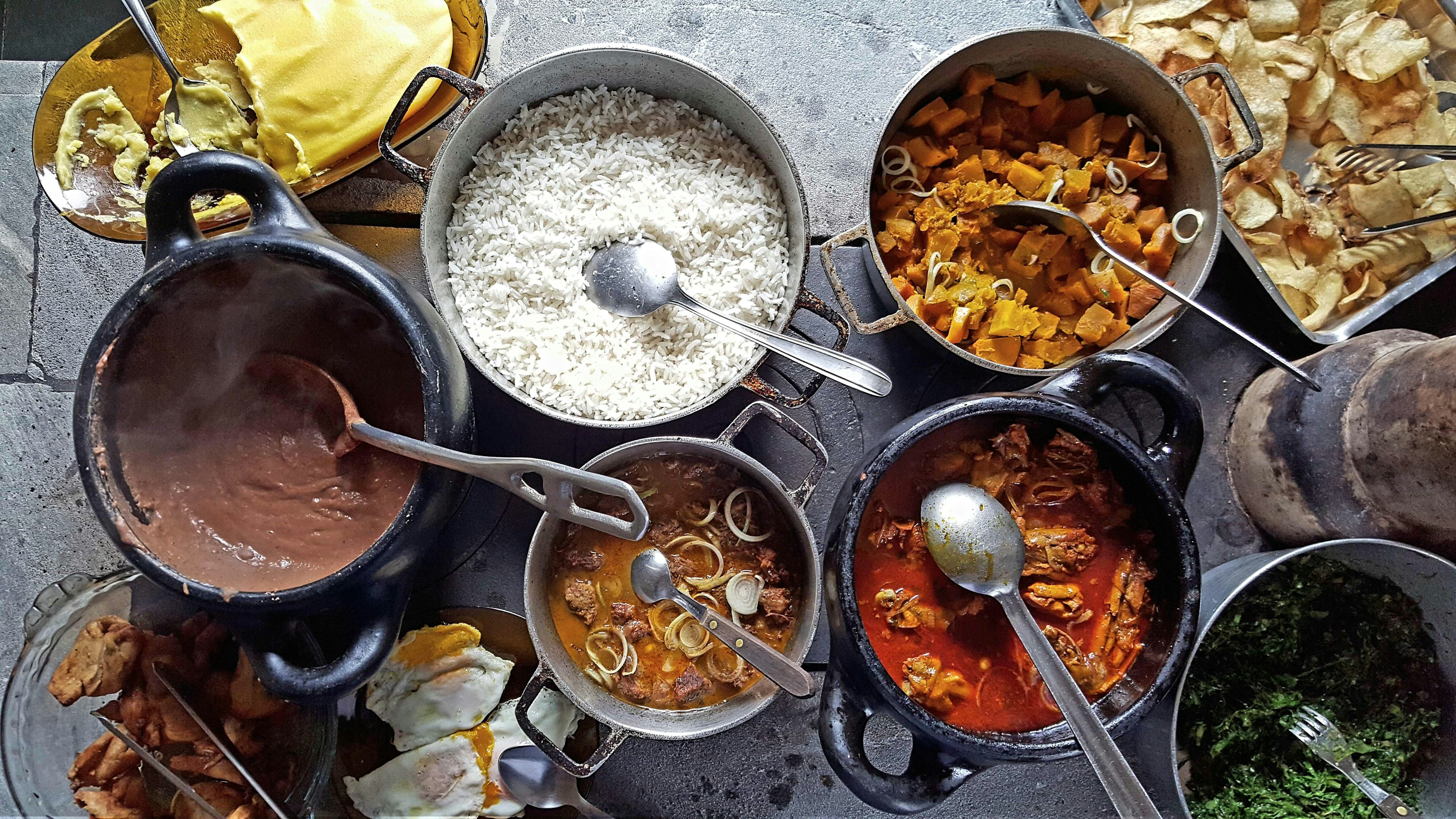 A variety of Indian dishes sitting on a wooden table