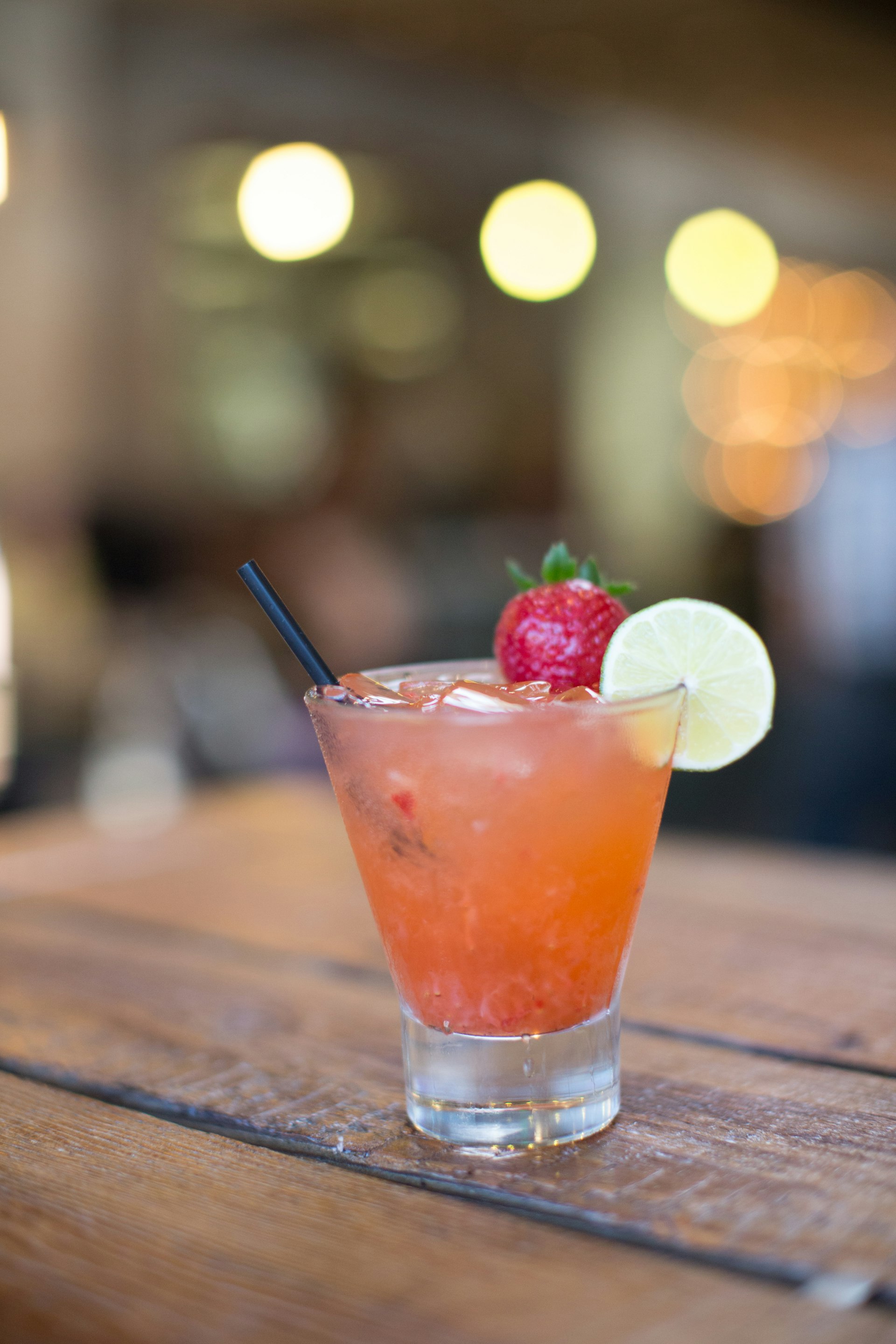 Beautifully presented pink cocktail at bar in Los Angeles at sunset