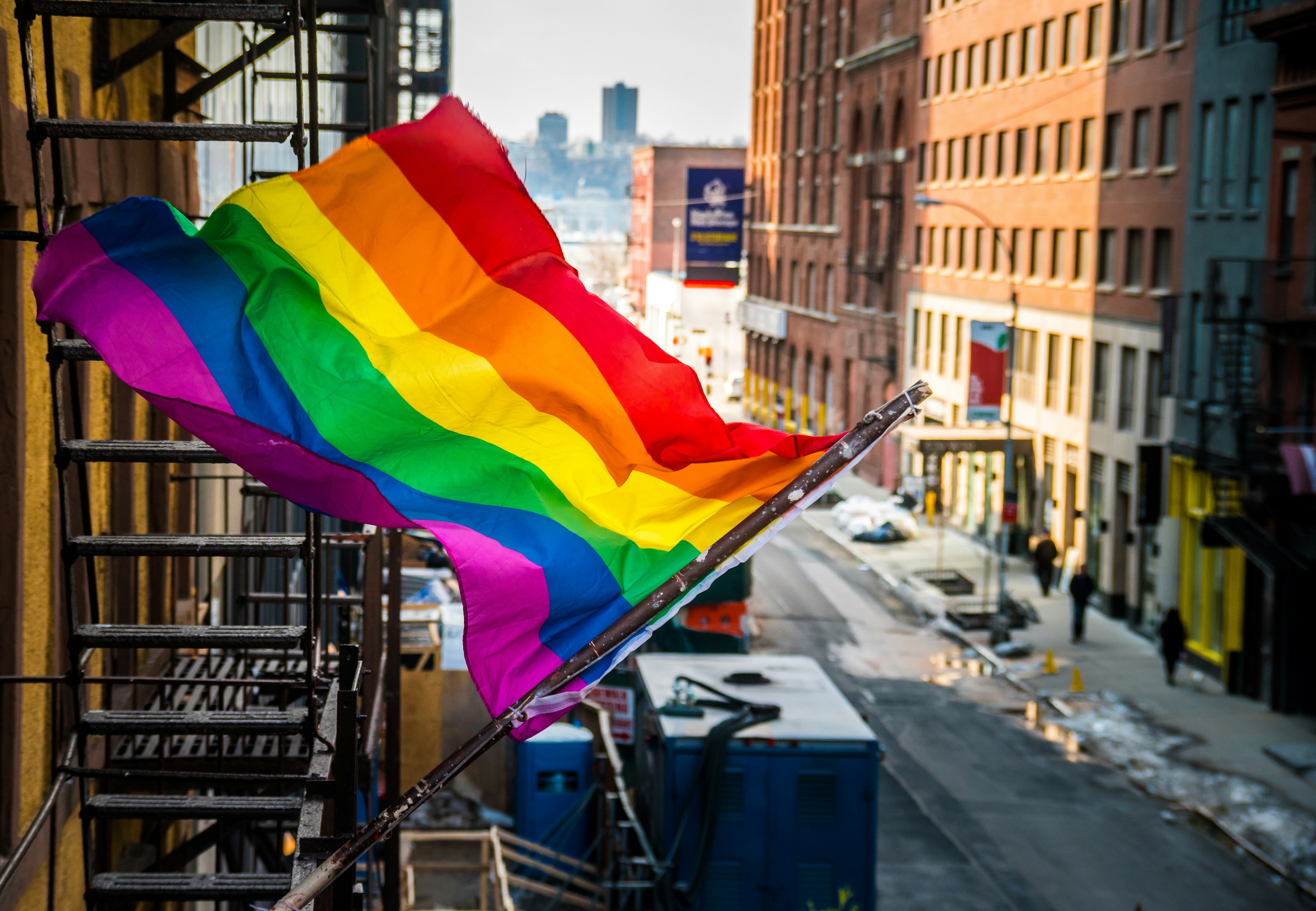 Rainbow flag flying from a building on Manhattan's West Side, seen from the High Line Park, near Chelsea.