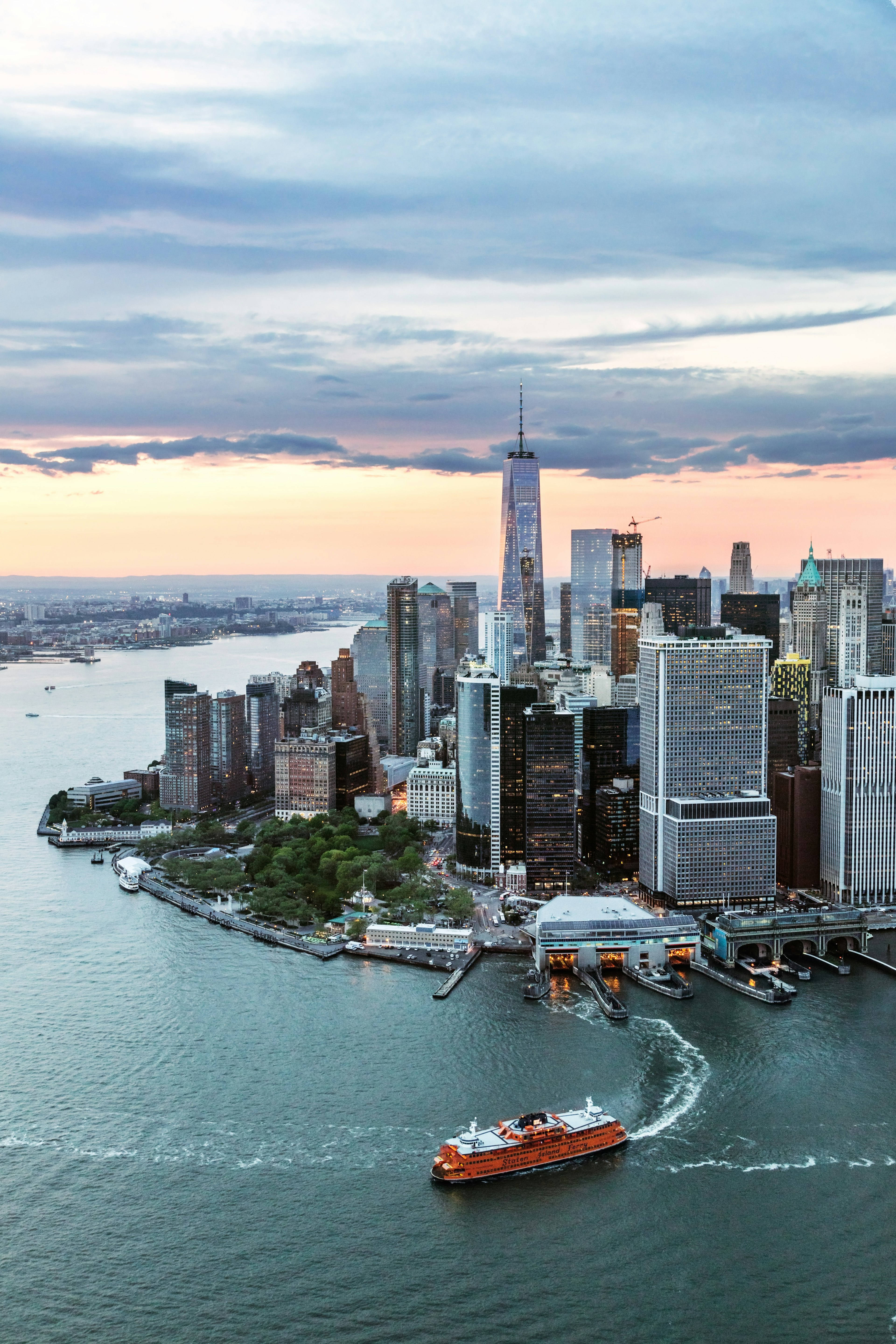 Aerial view of a city with glass-and-steel skyscrapers on the edge of a river