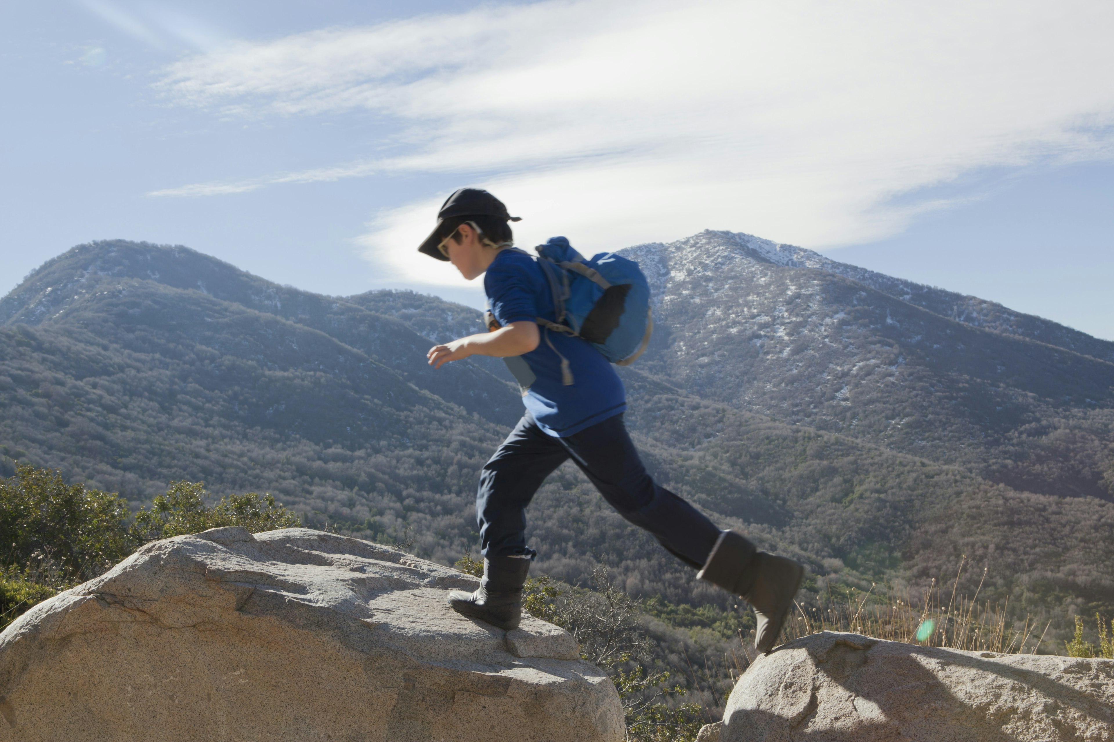 A child running across boulders in Middle Chile.