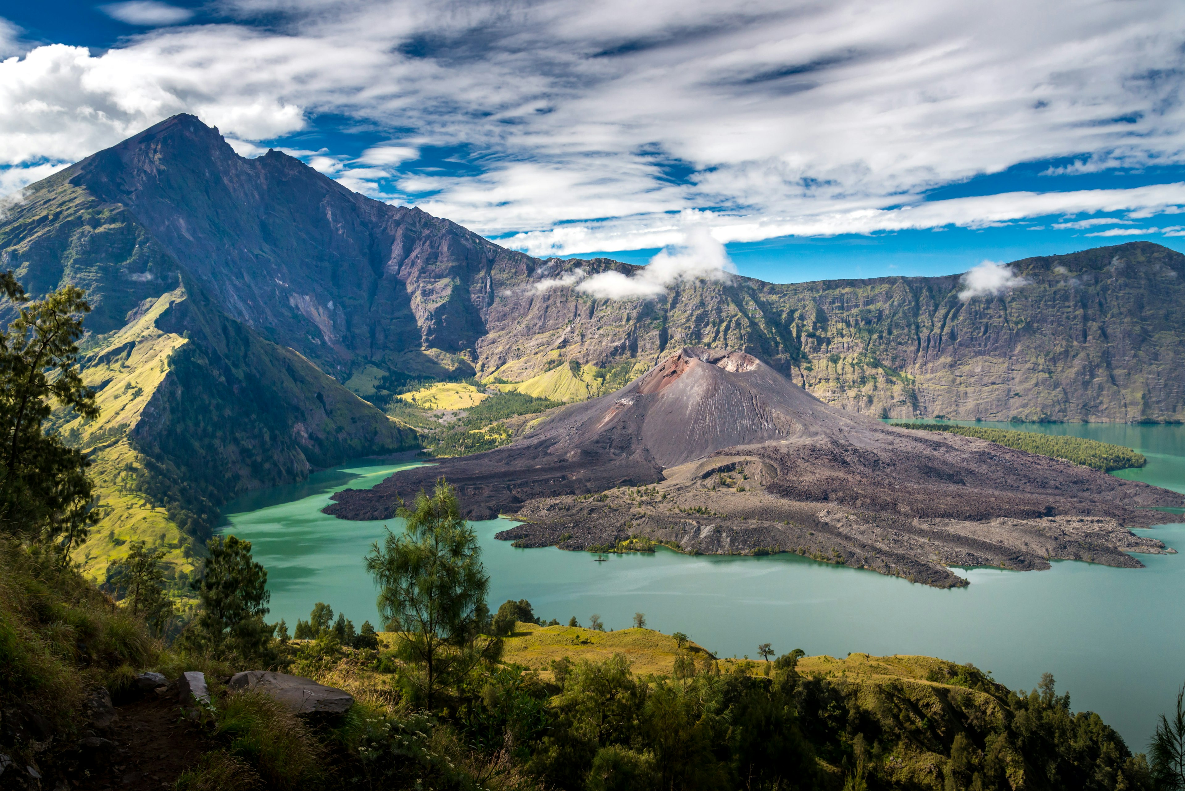 A volcanic crater lake with a volcanic peak in the center