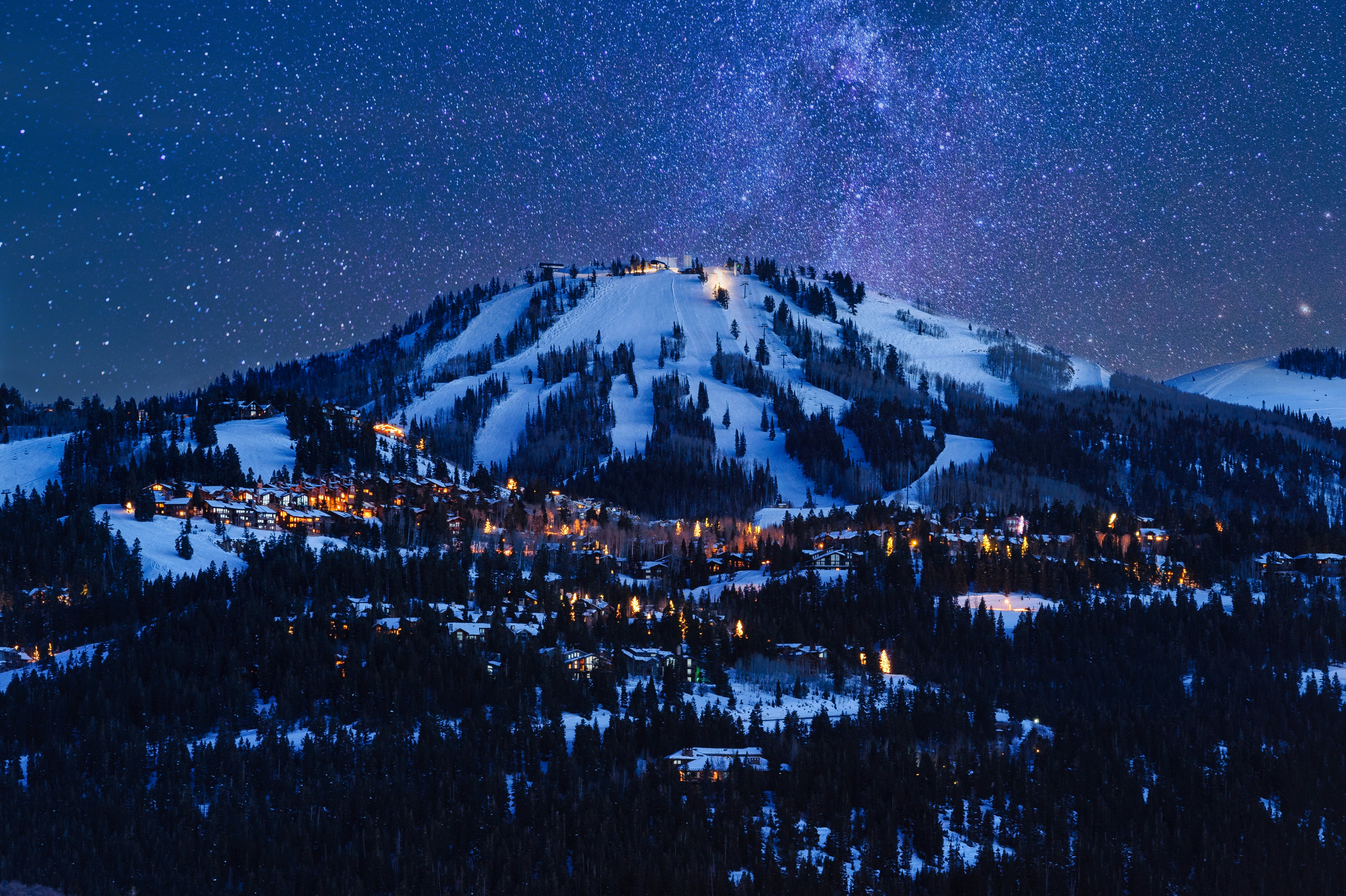 Deer Valley Park City at dusk with snow capped mountain in the background