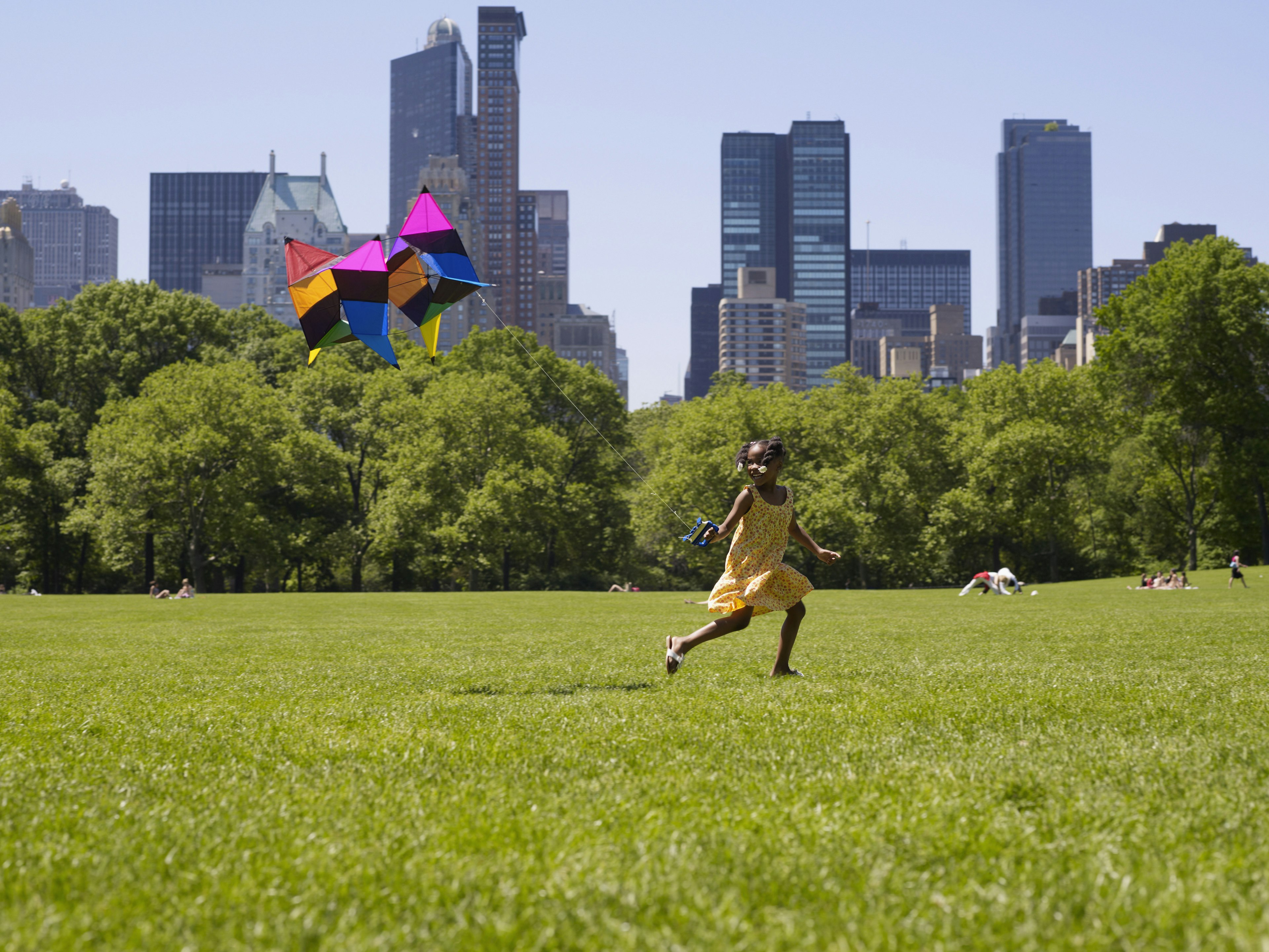 A young girl flying kite in Central Park