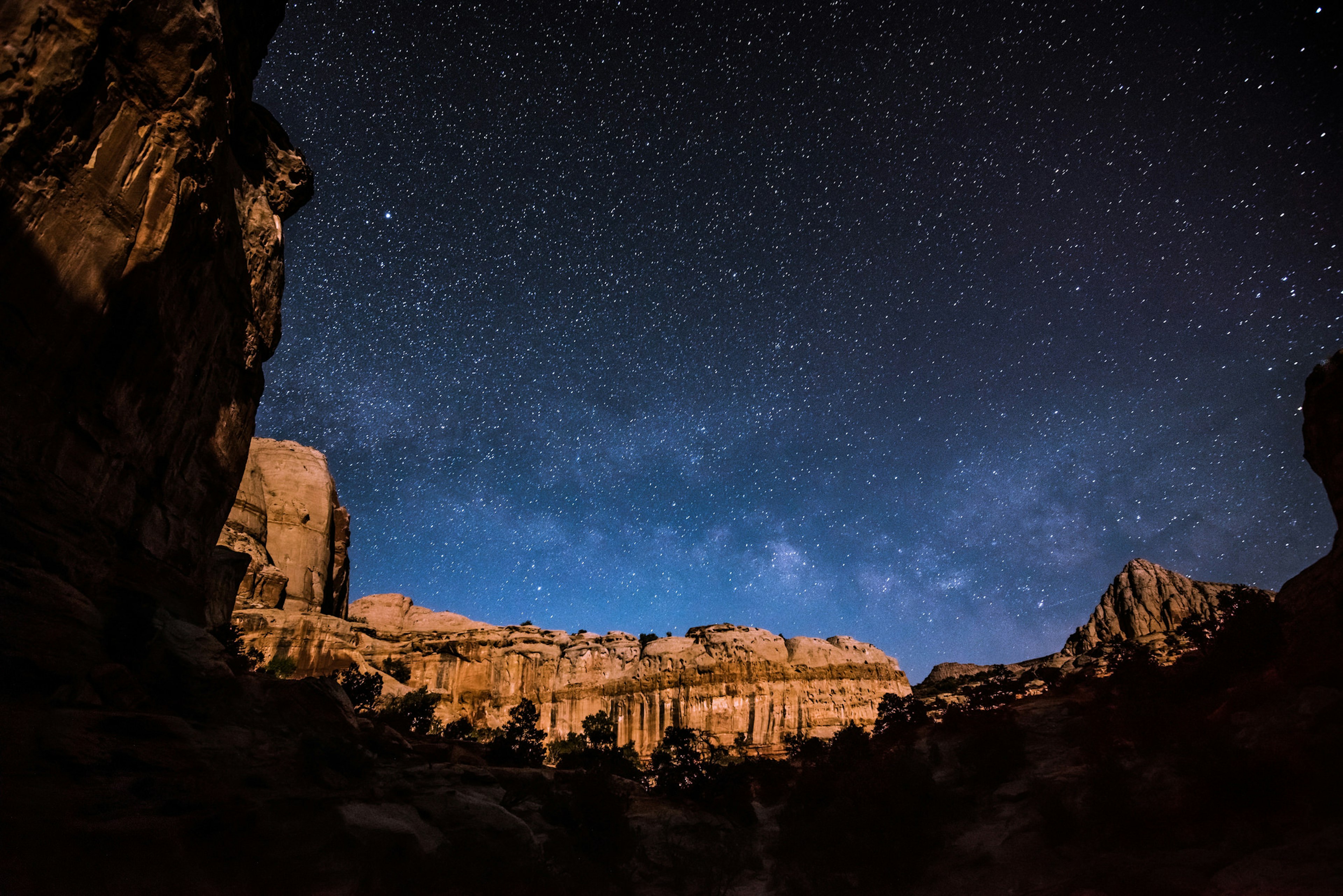 Starry sky over butte at night in Capitol Reef National Park.