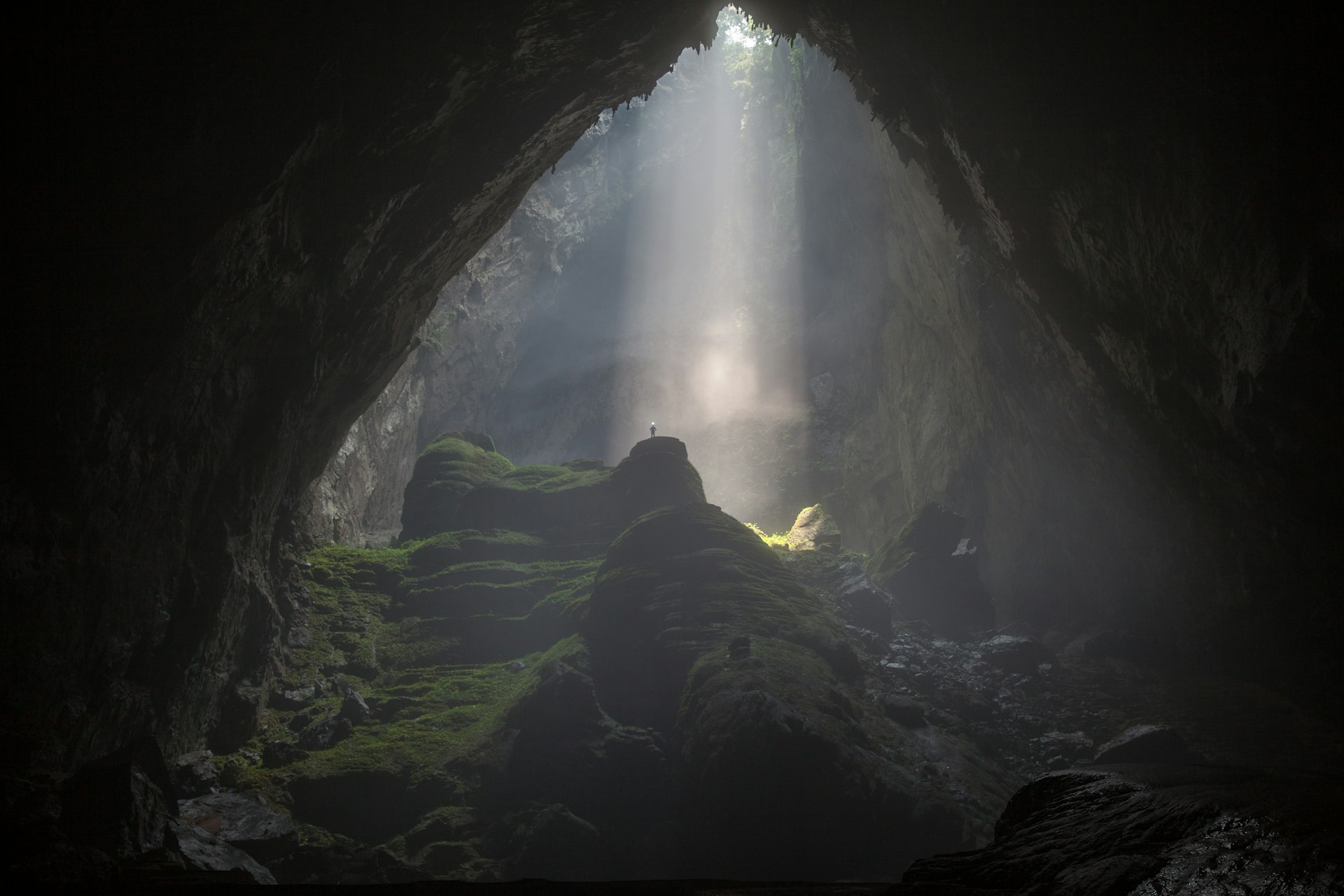 A doline creates a beam of light inside Hang Son Doong cave. 