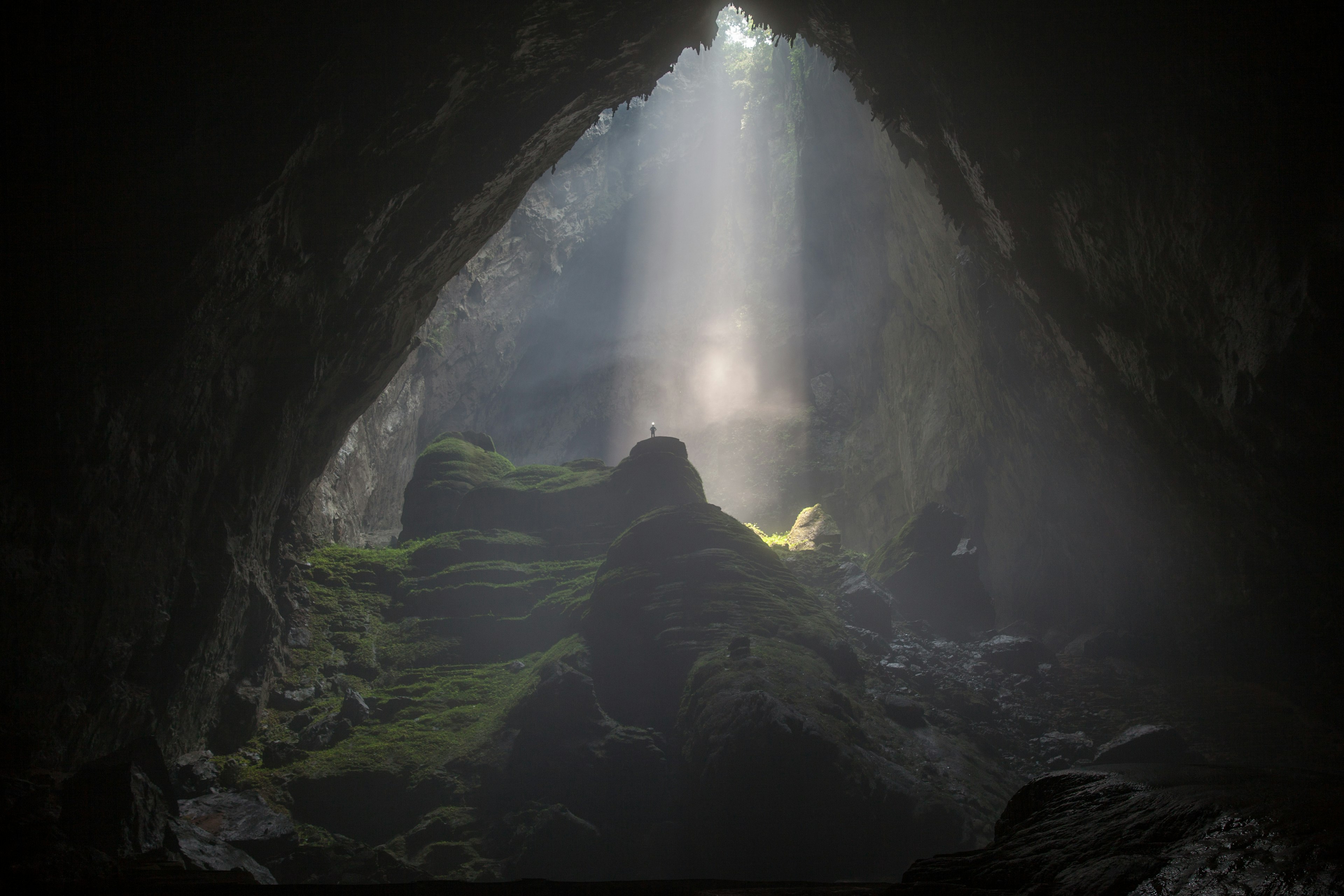 A doline creates a beam of light inside Hang Son Doong cave.