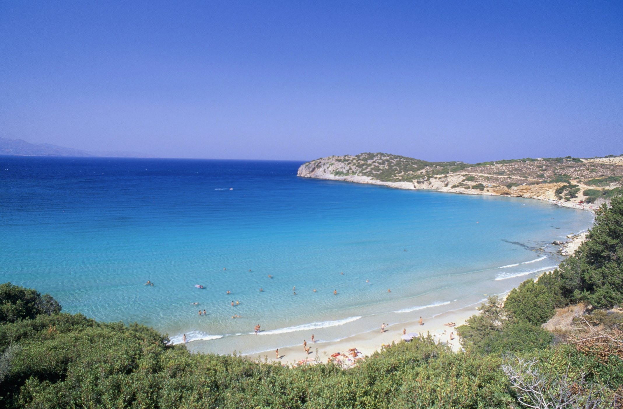 Sunbathers on a sandy beach near the town of Gournia