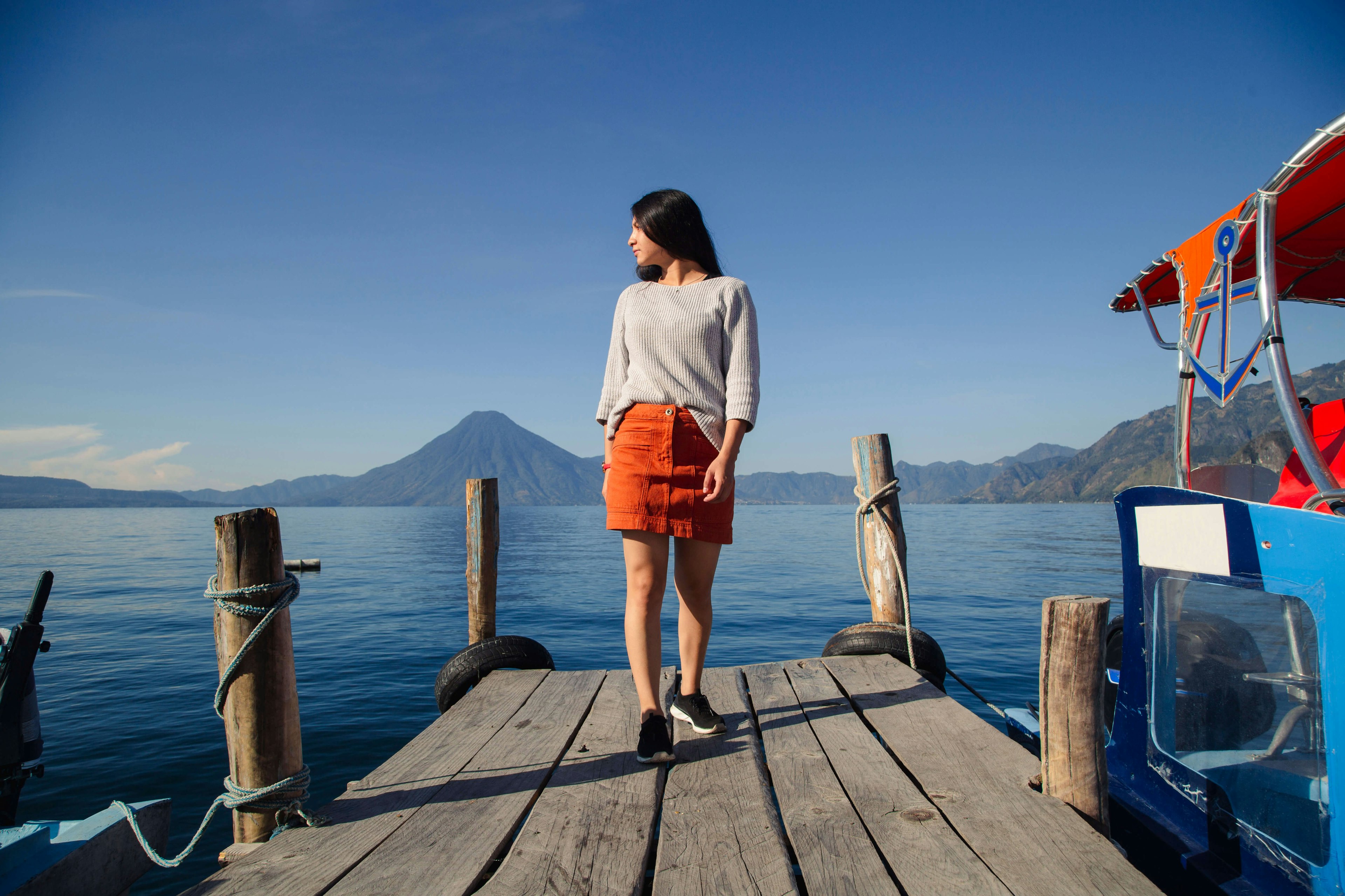 Hispanic woman on a pier beside Lake Atitlán (Lago de Atitlán) in Guatemala