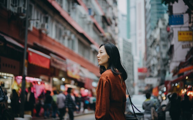 Young Asian woman exploring and strolling in local street market in Hong Kong