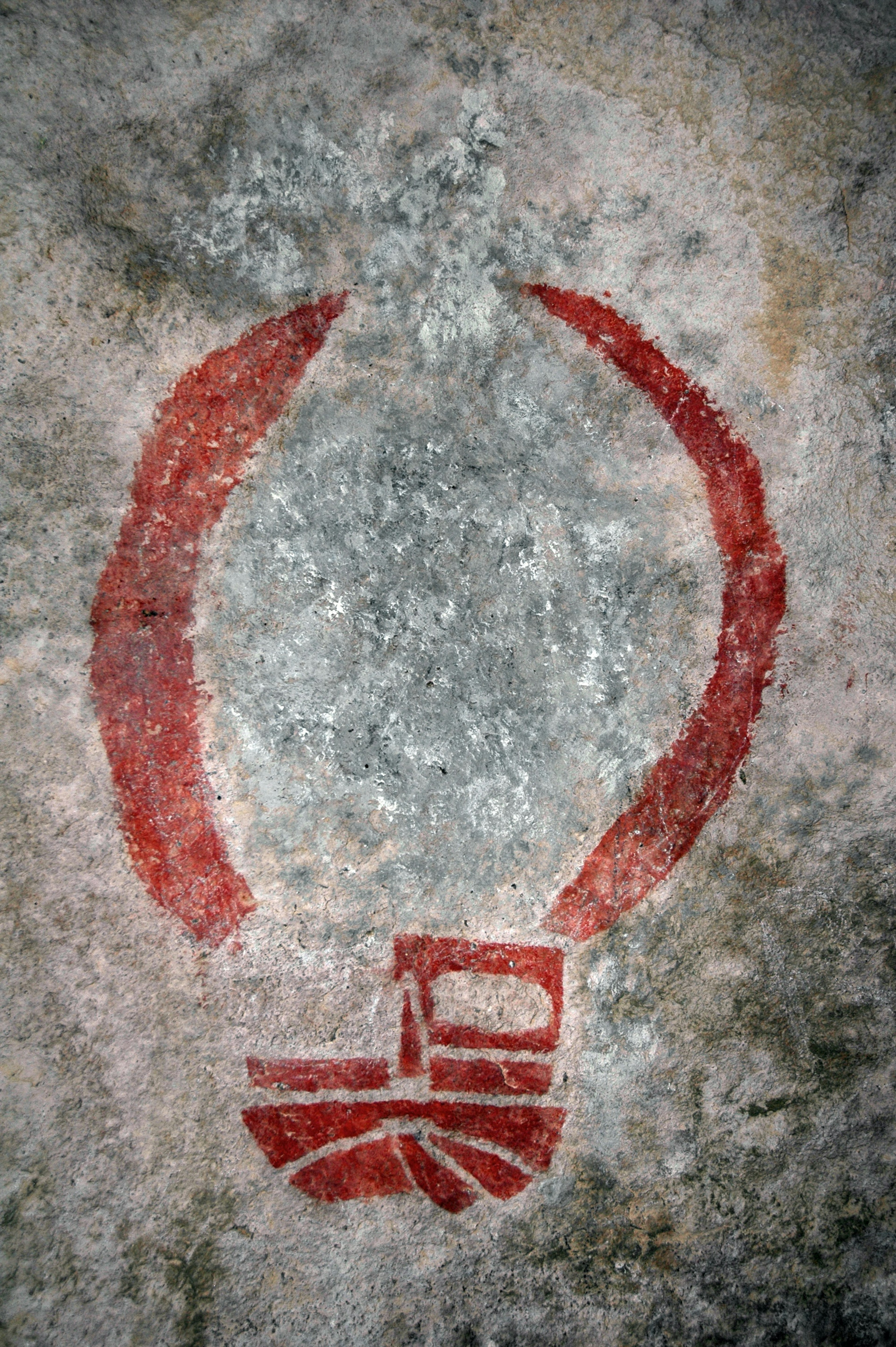 Red rock art on the walls of a cave in Hueco Tanks State Park in Texas.