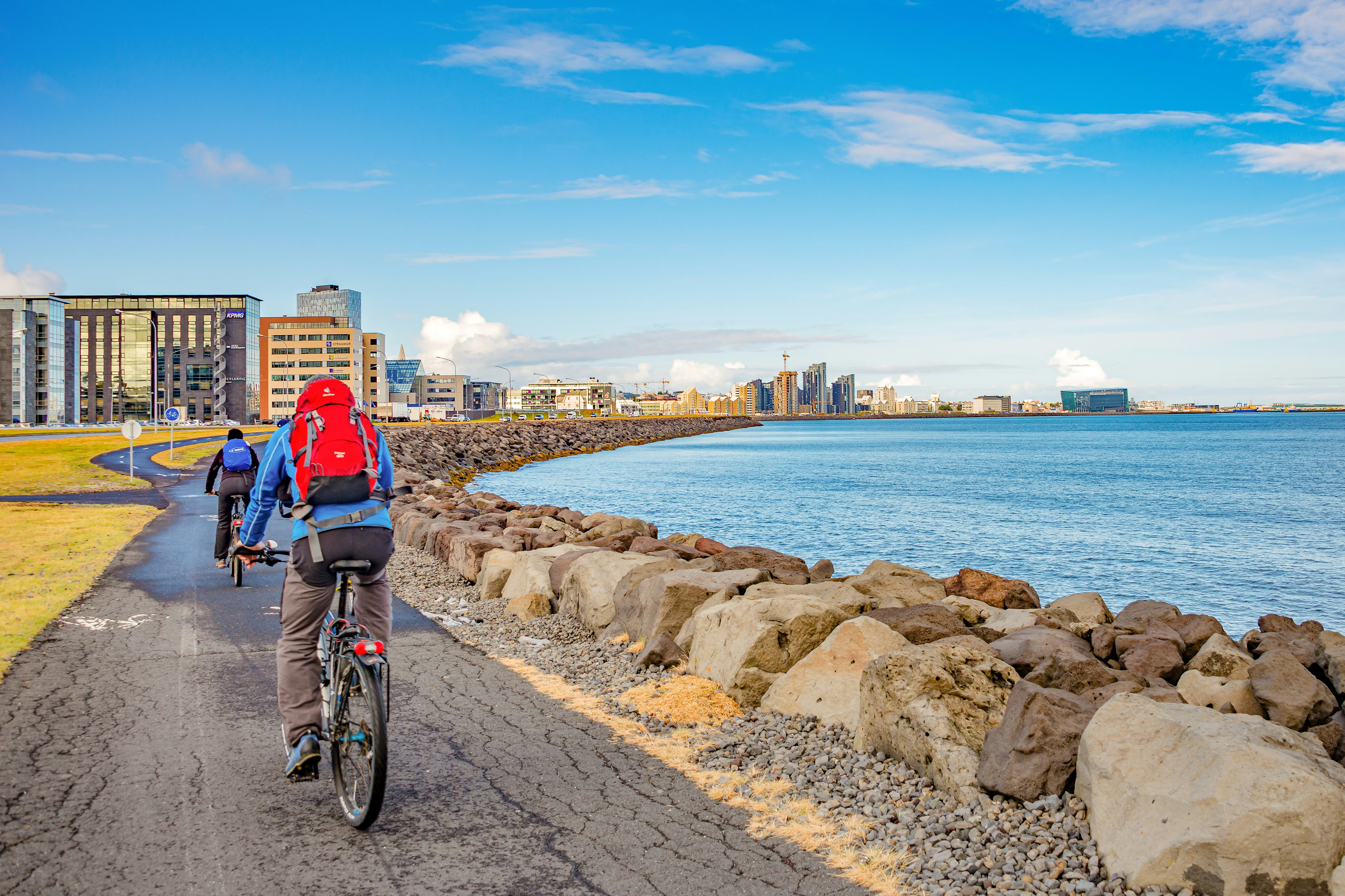 Cyclists following a shoreline cycle path in Reykjavik