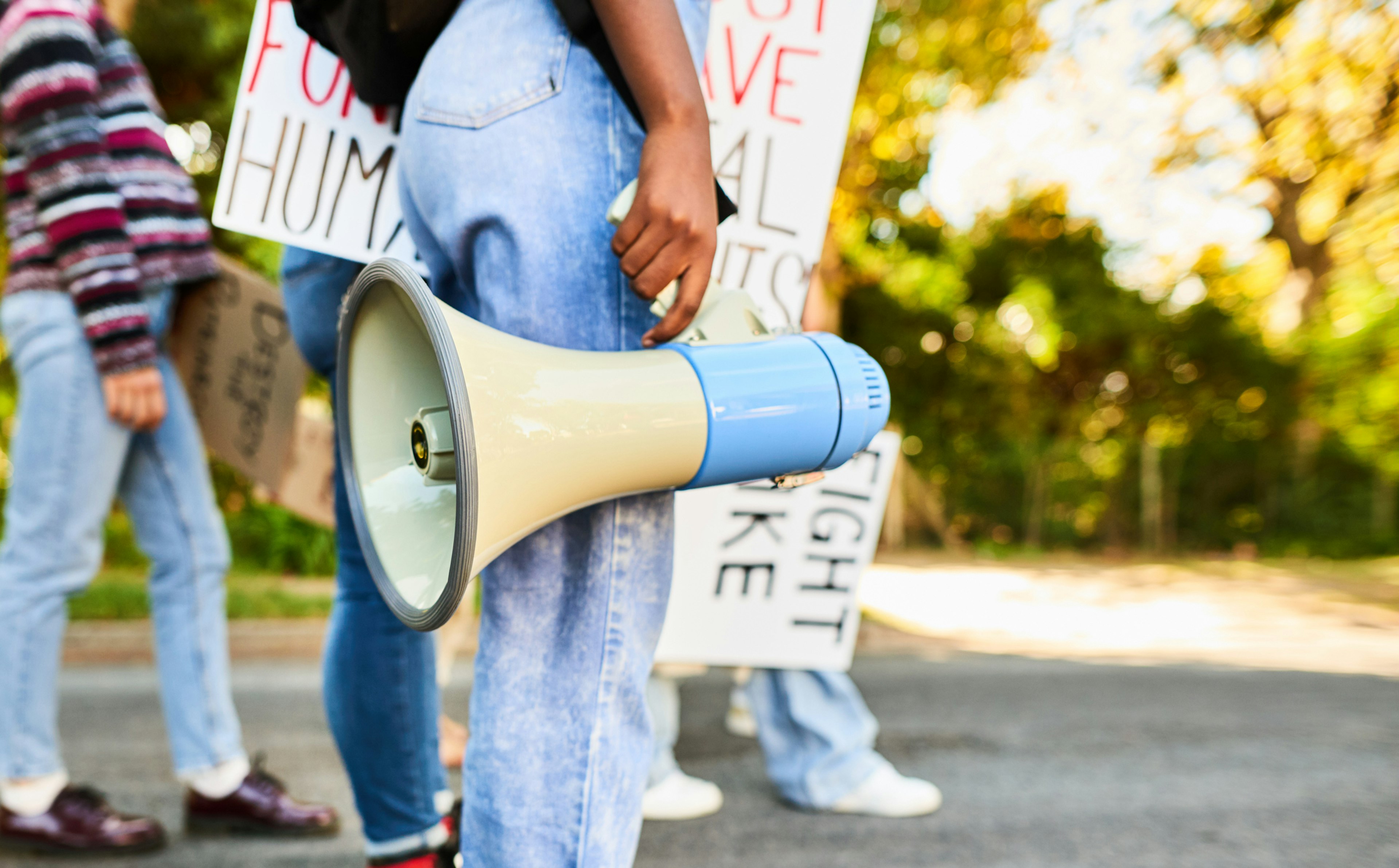 Woman standing with a megaphone during a women's rights day march