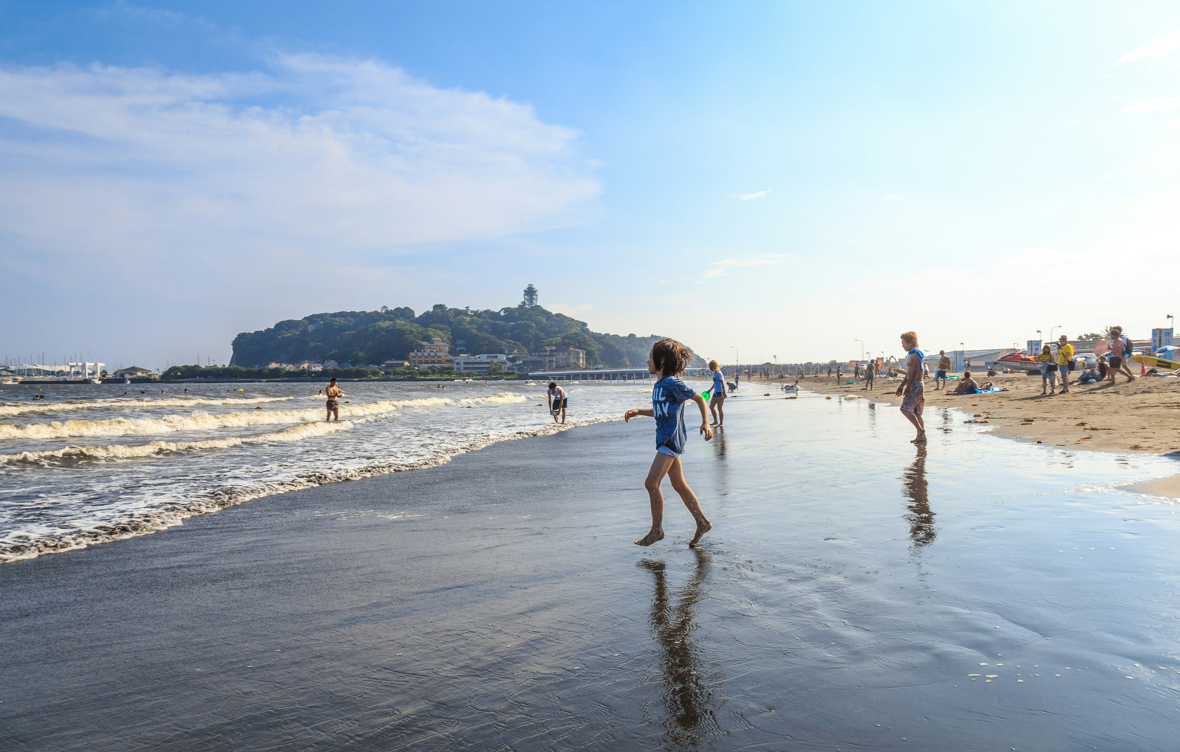 A boy is going to the Katase Higashihama beach against the sky, Fujisawa-kanagawa, Japan