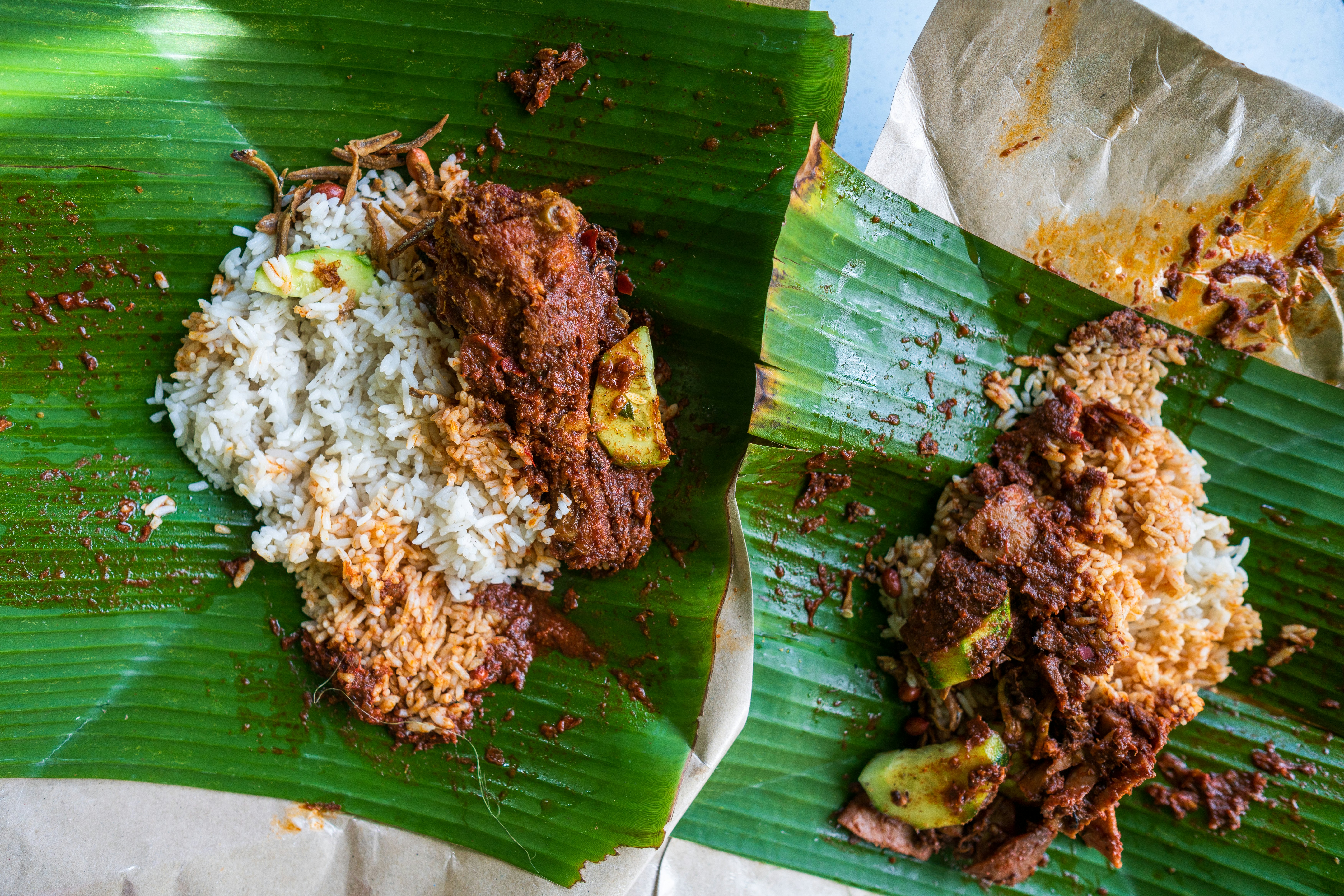 Nasi lemak, a Malaysia rice fish, sits on a pandan leaf.