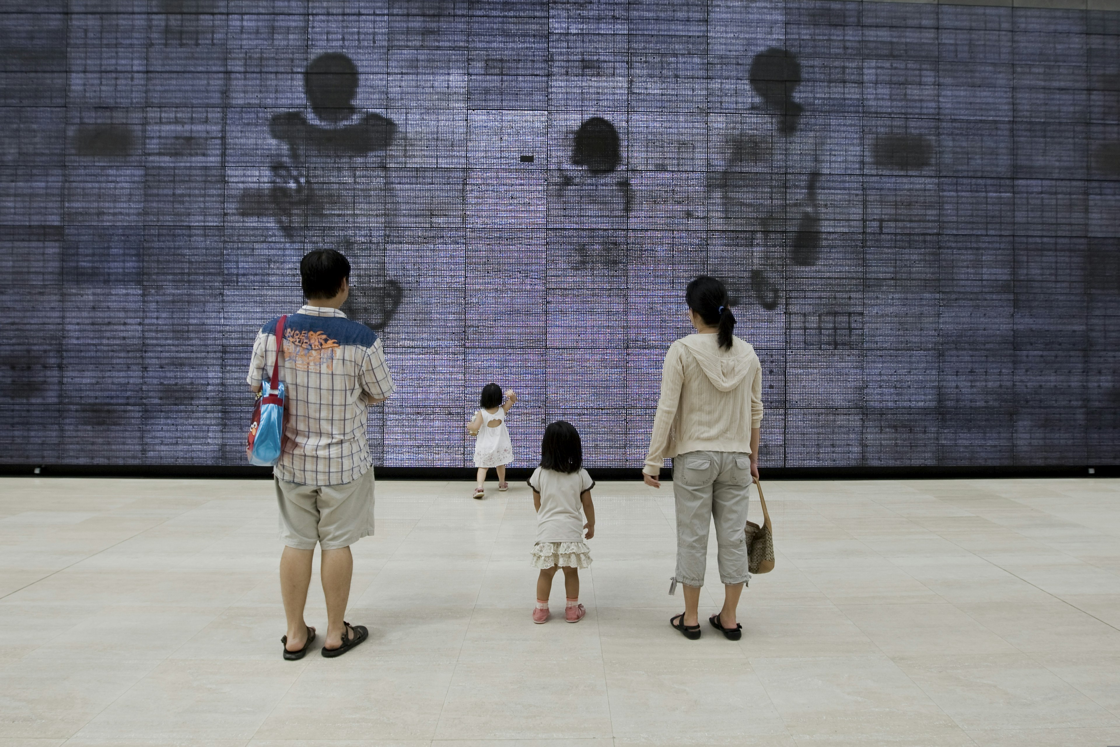 Family looking at work at the National Museum of Singapore