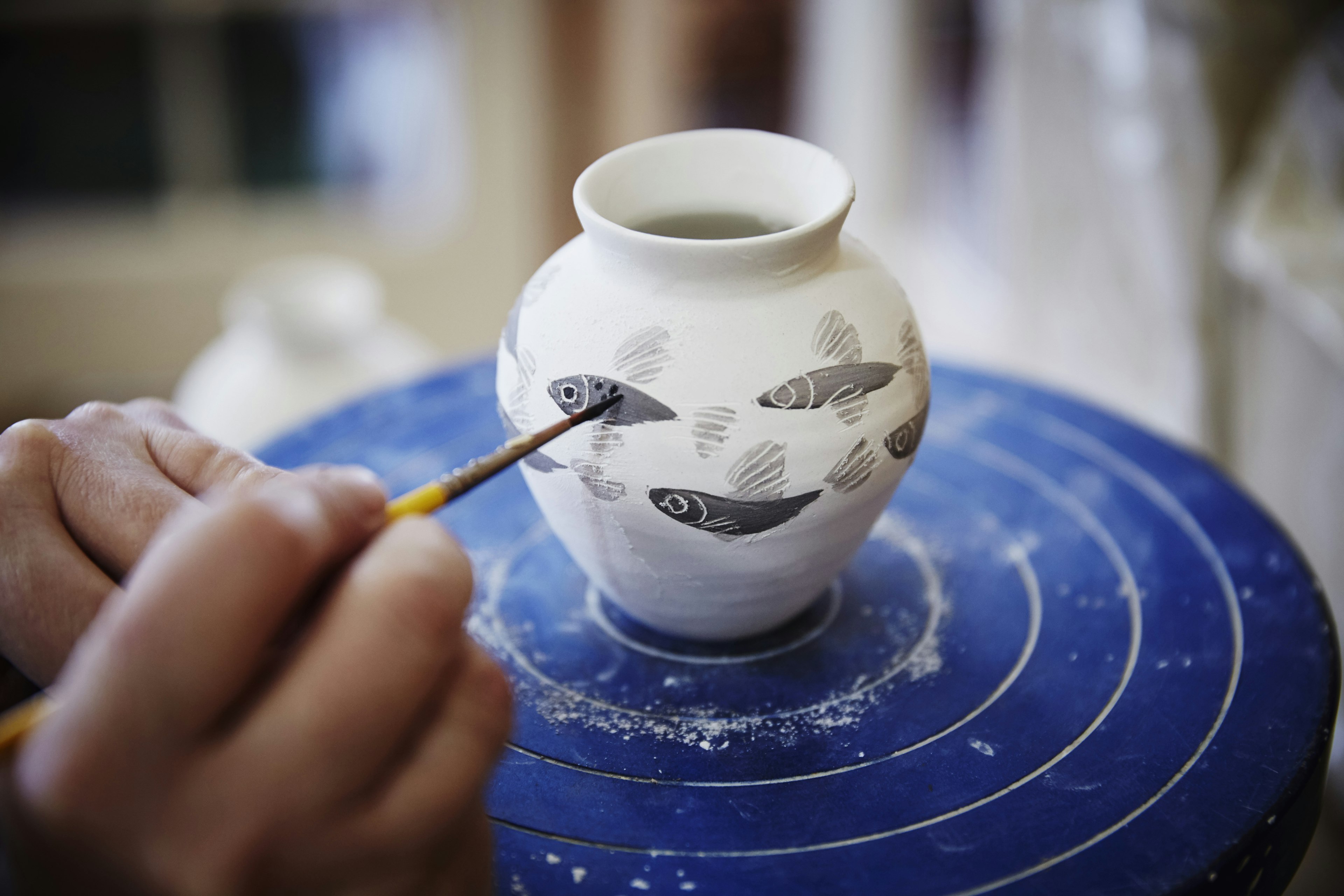 Painting pottery at the ShackletonThomas studios, near Woodstock.