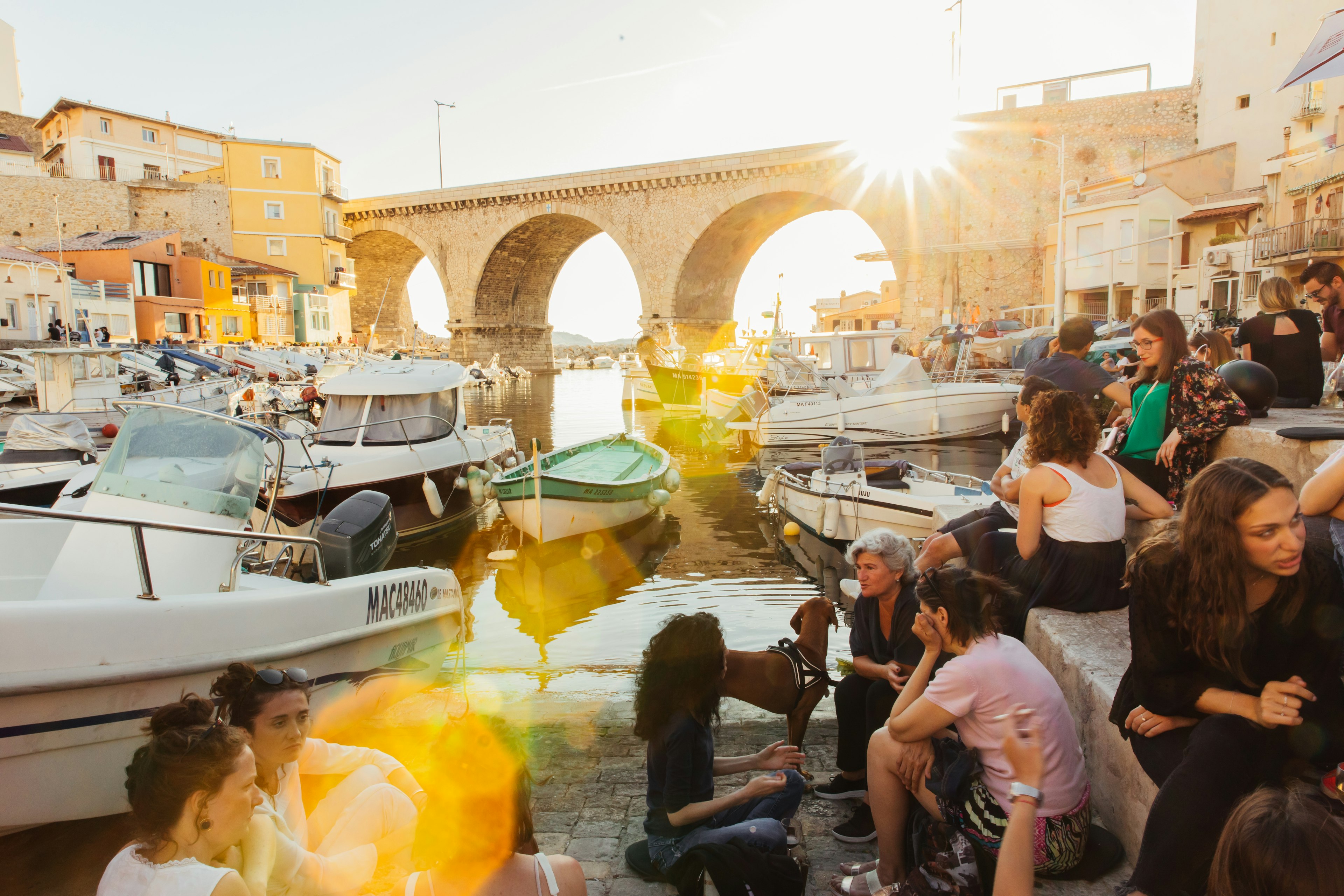 Group of people catching the sunset at Vallon des Auffes, a mini fishing port in Marseille once home to many Italian and Spanish immigrants.