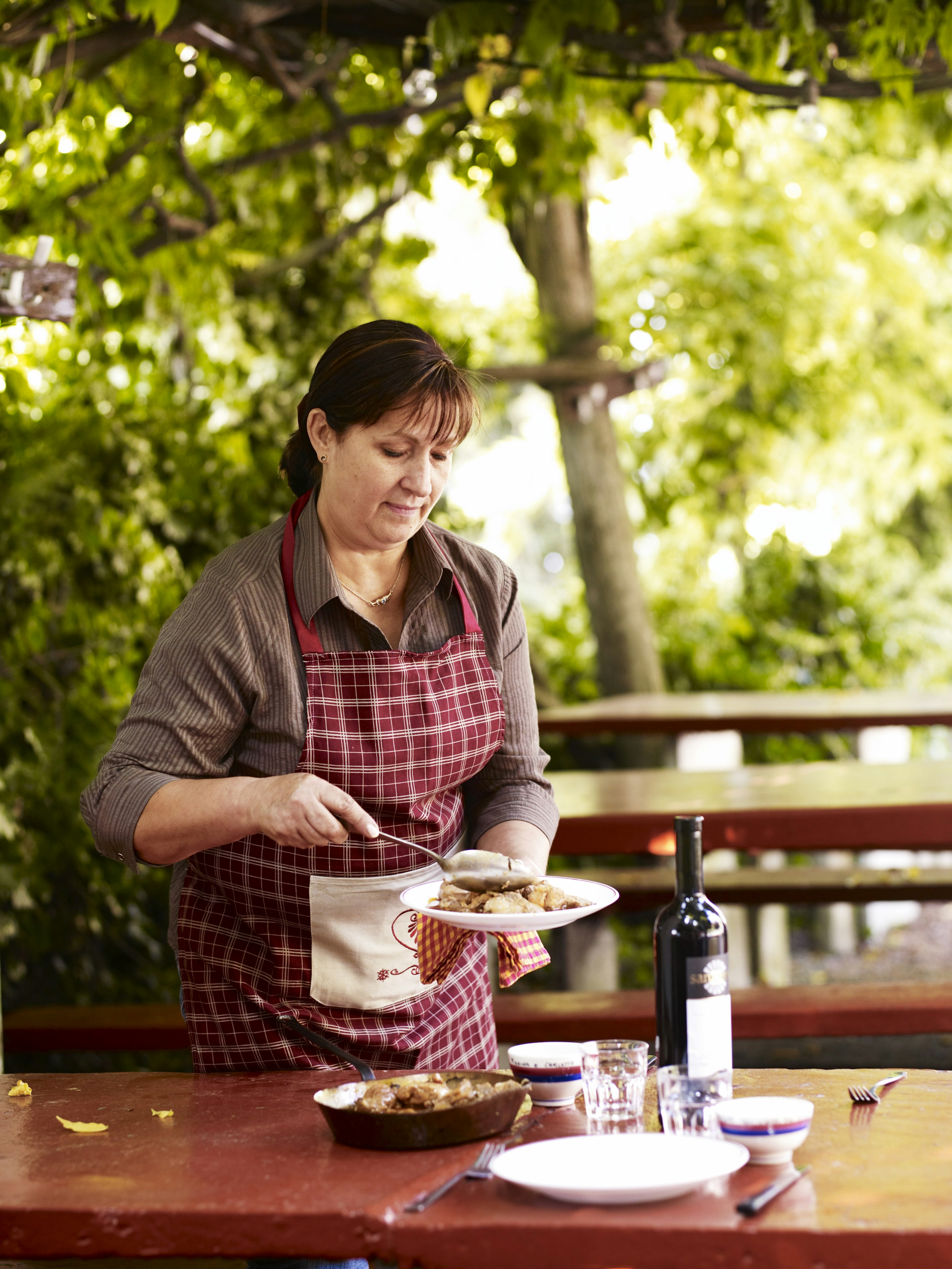 Chef dishing up rabbit stew at Grotto Pierino.