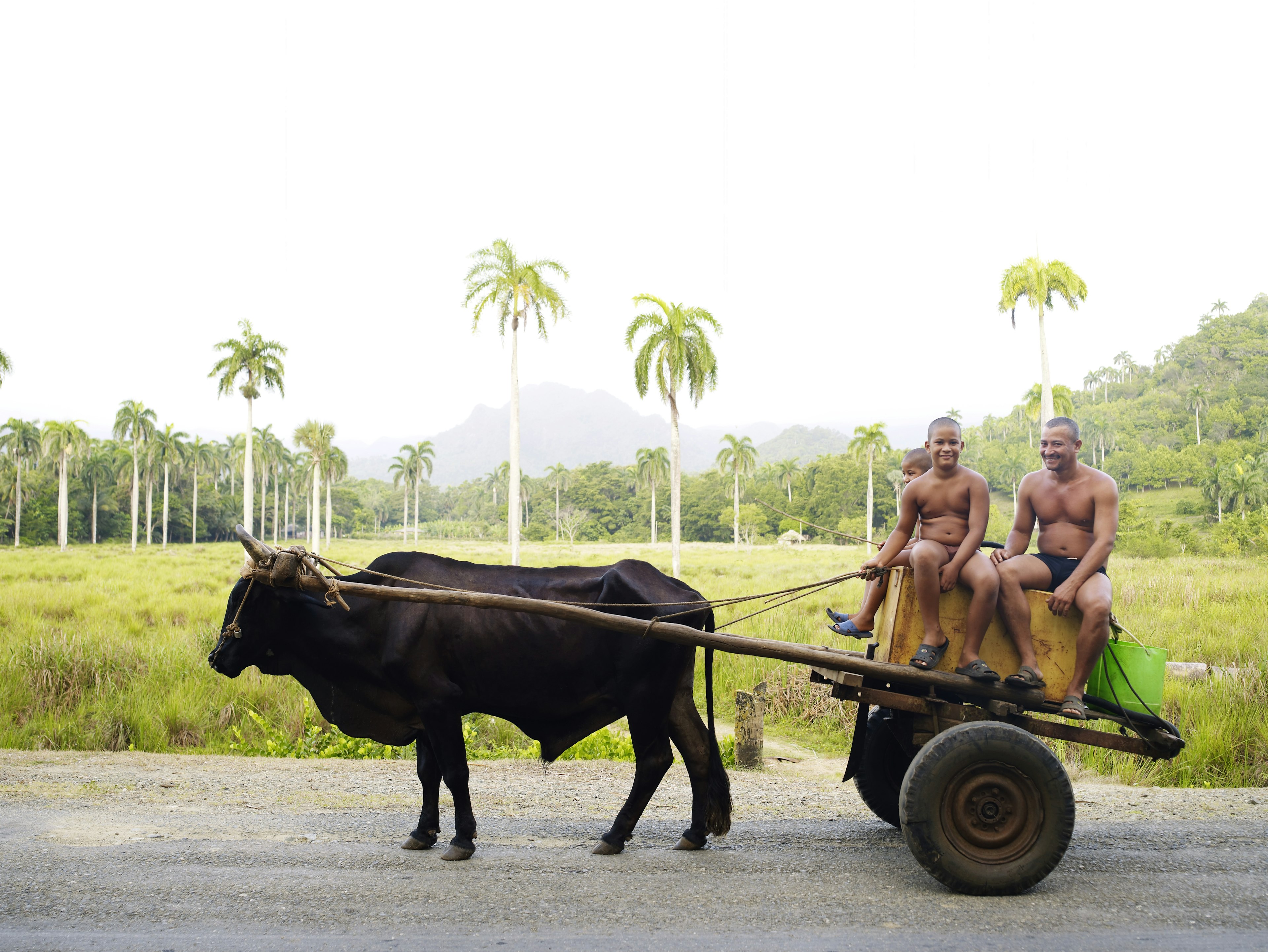 People riding on a bullock cart on the road between Santiago de Cuba and Baracoa, Cuba