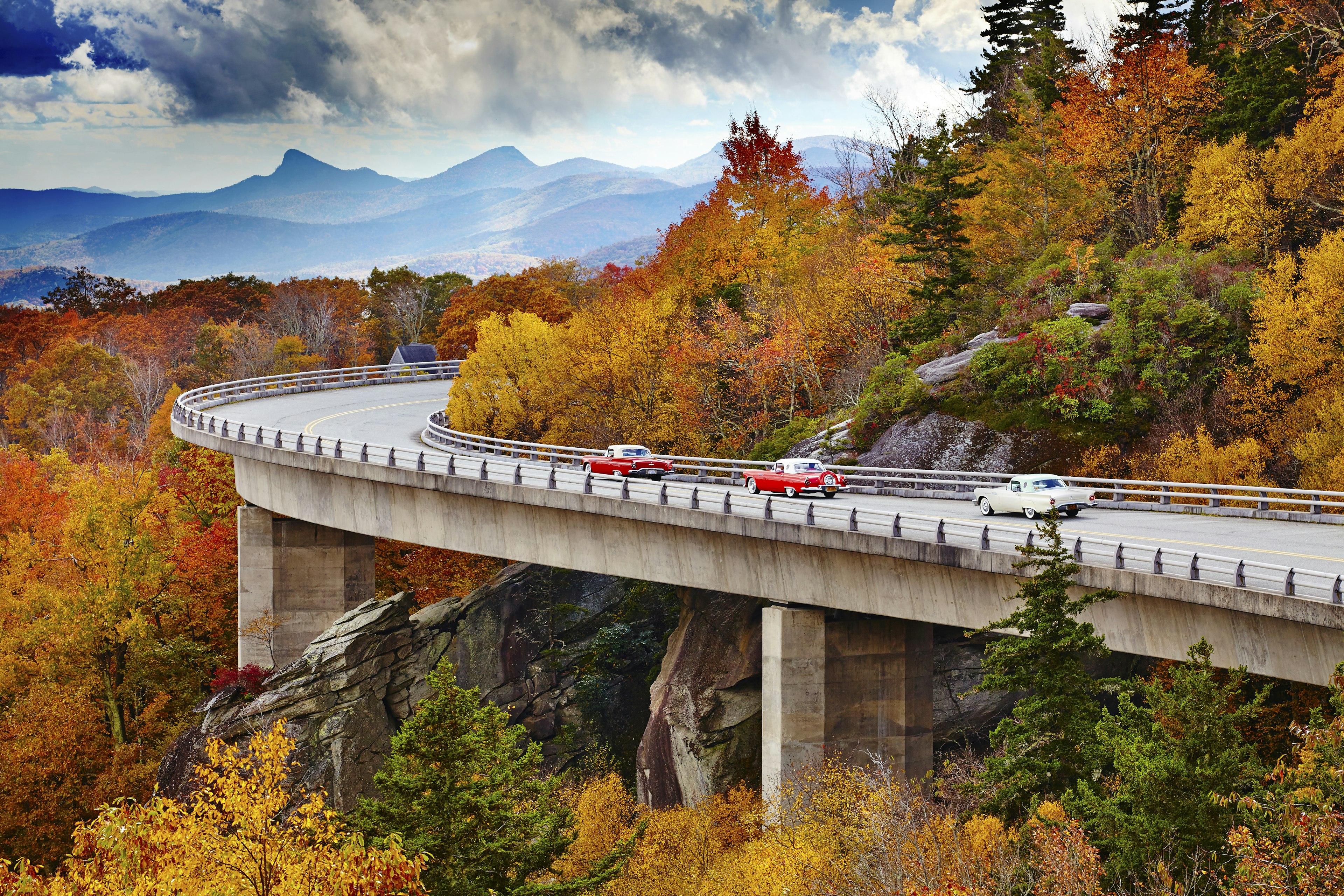 Classic cars on Linn Cove Viaduct in fall, Blue Ridge Parkway Scenic Drive