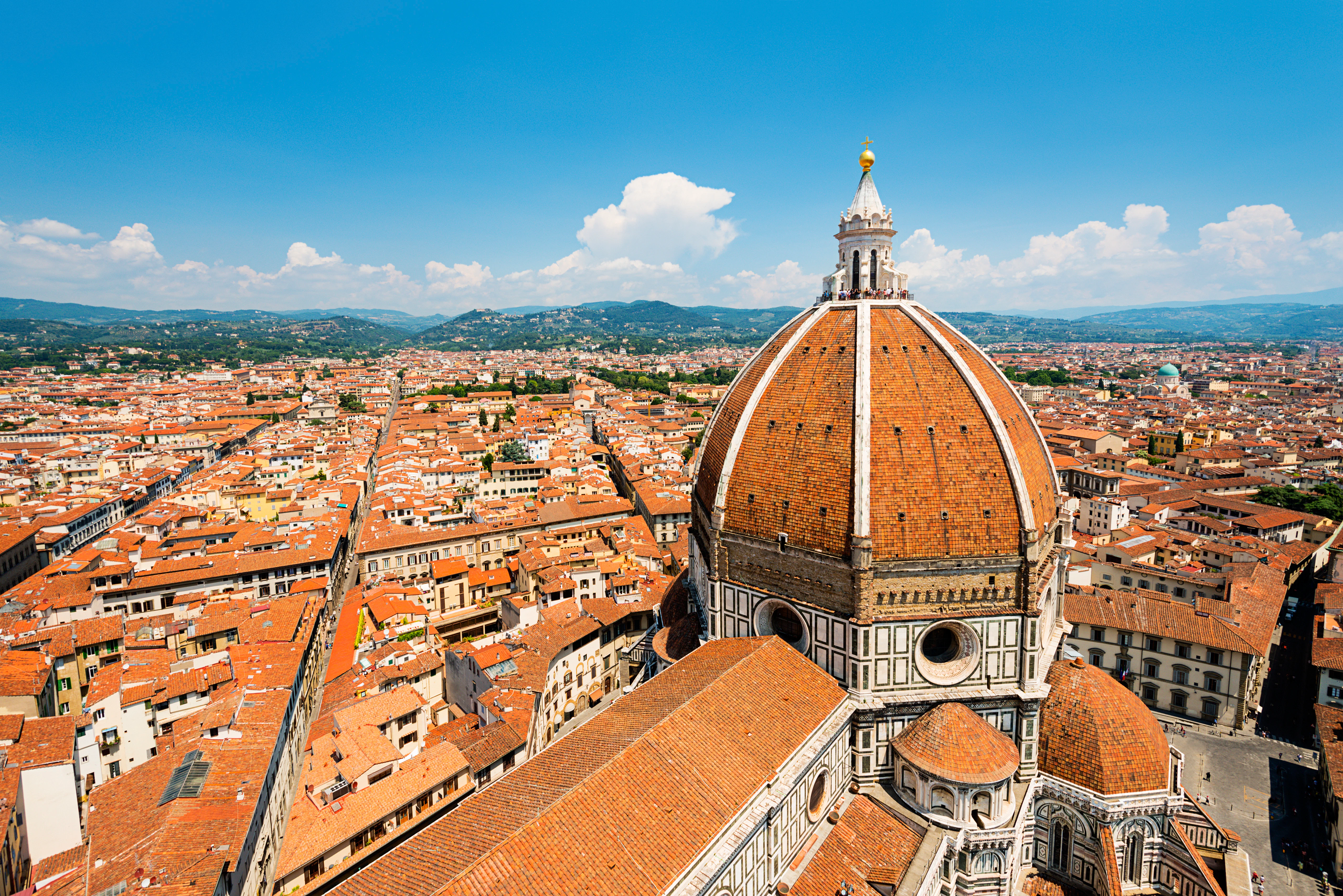 The dome of the Duomo in Florence, Tuscany, Italy, with views over the terracotta tiled rooftops.