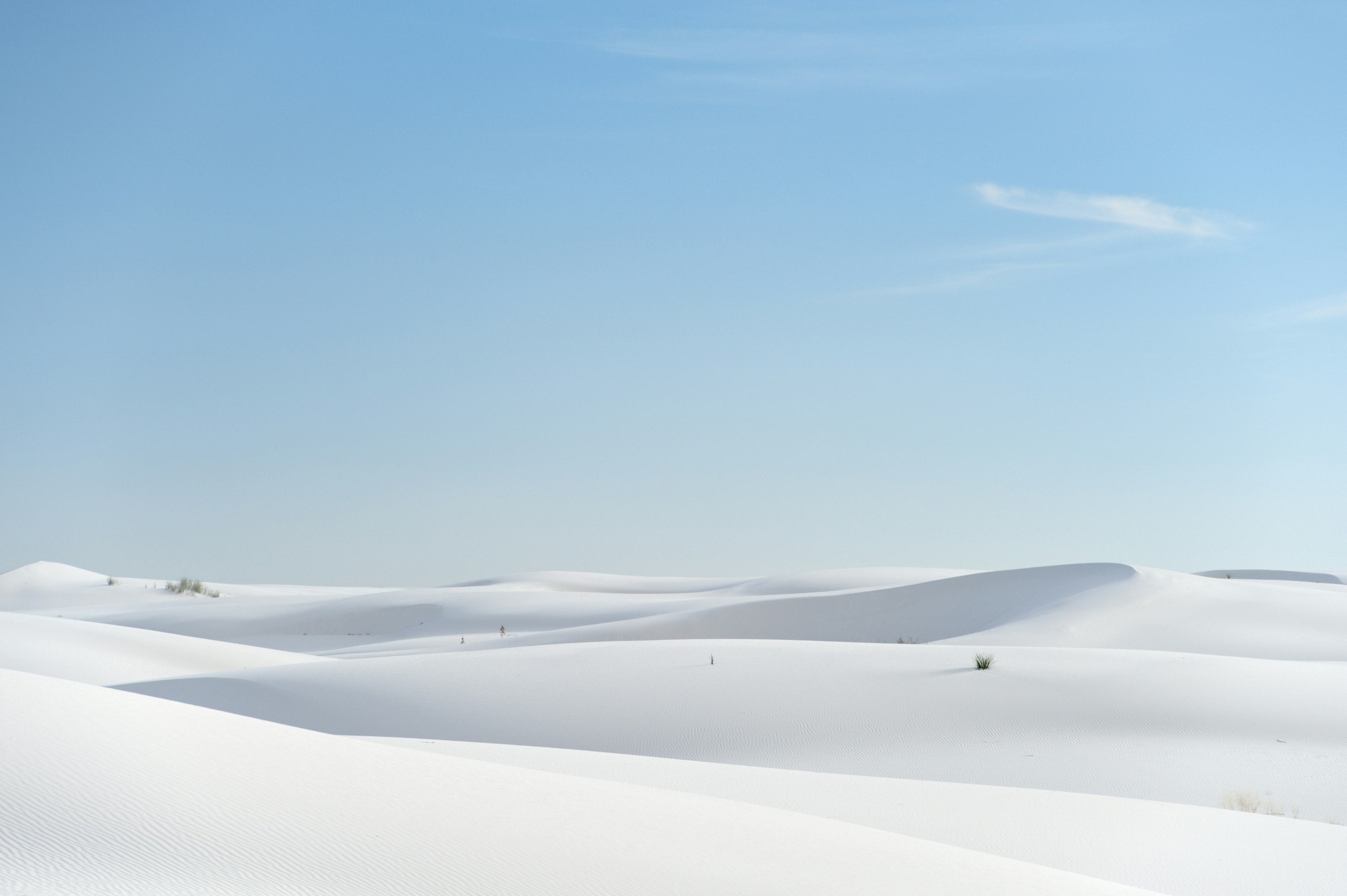 White dunes of sand under a blue sky