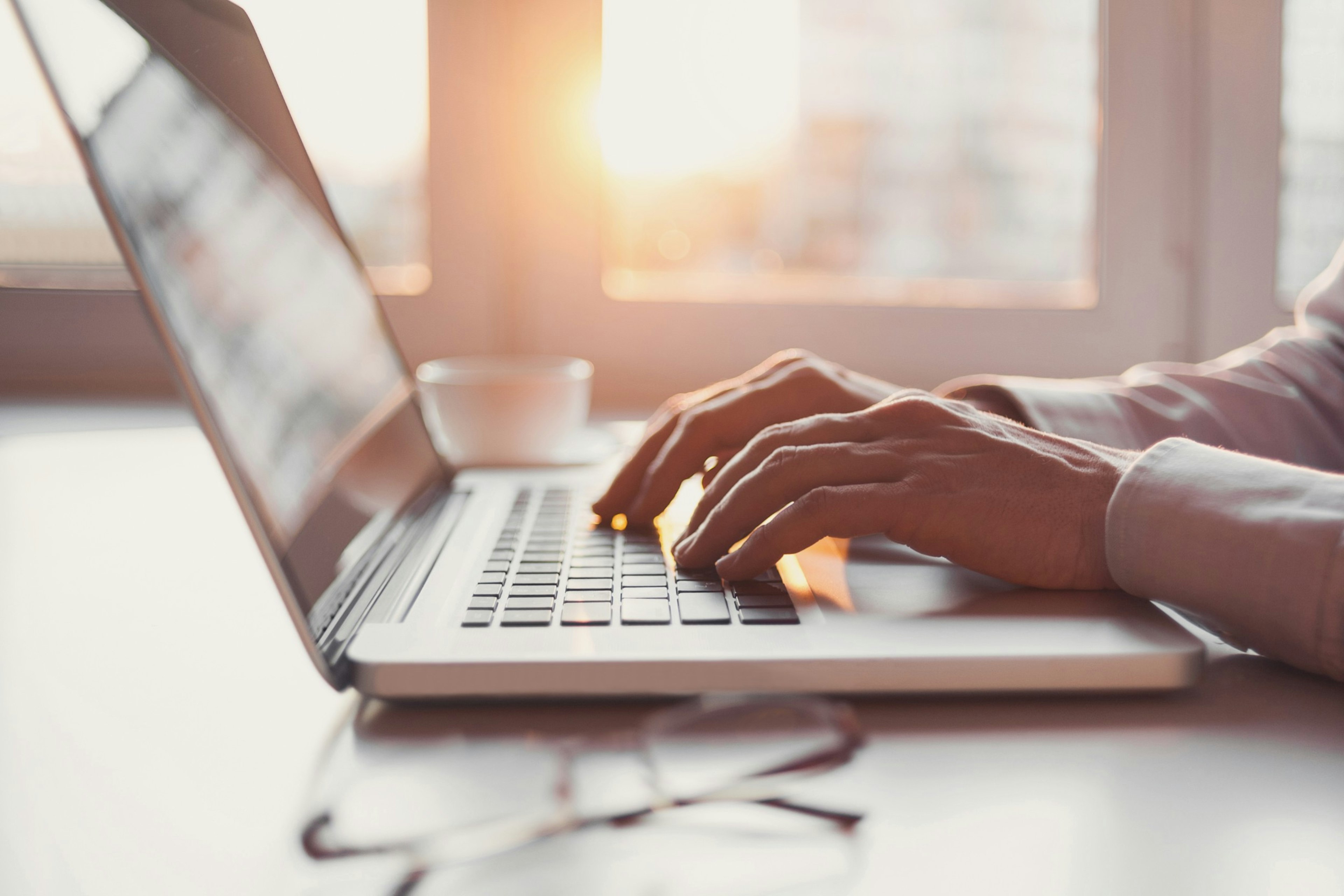 Hands on the keyboard of a laptop