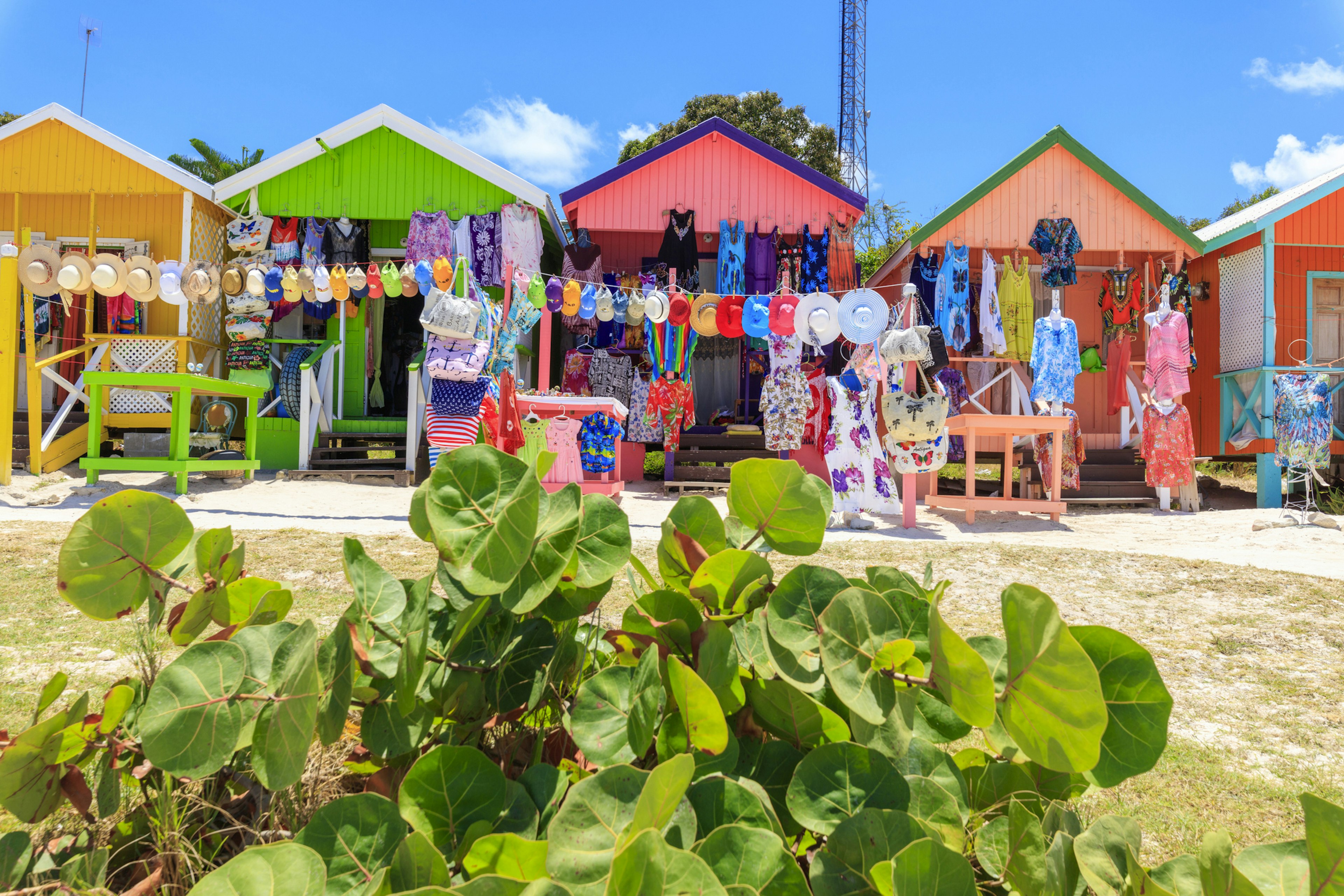 Multi colored wood cottages and tourist souvenir shops, Long Bay Beach, Antigua