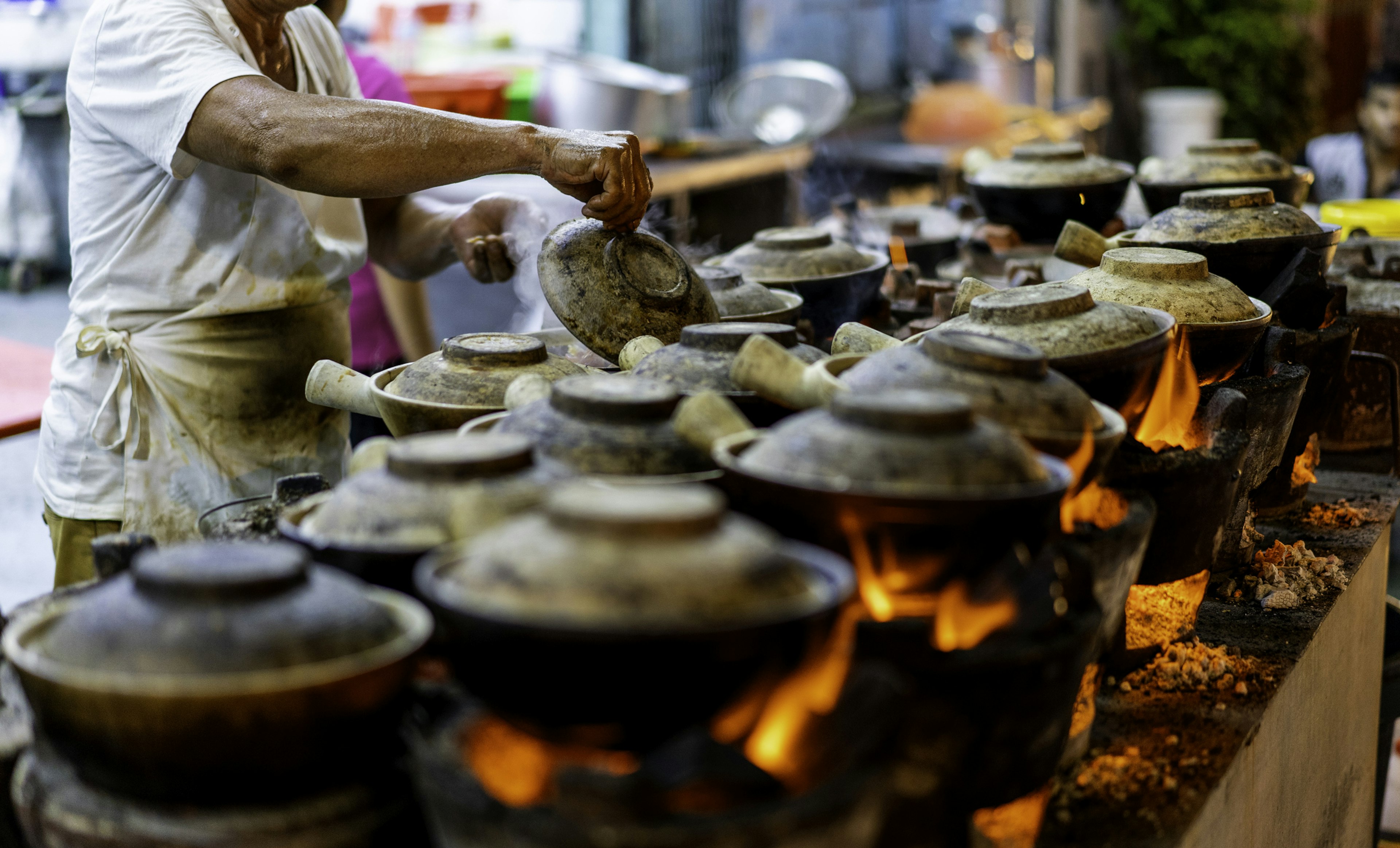 Malaysia Hawker clay pot of Chicken Rice with flames under it