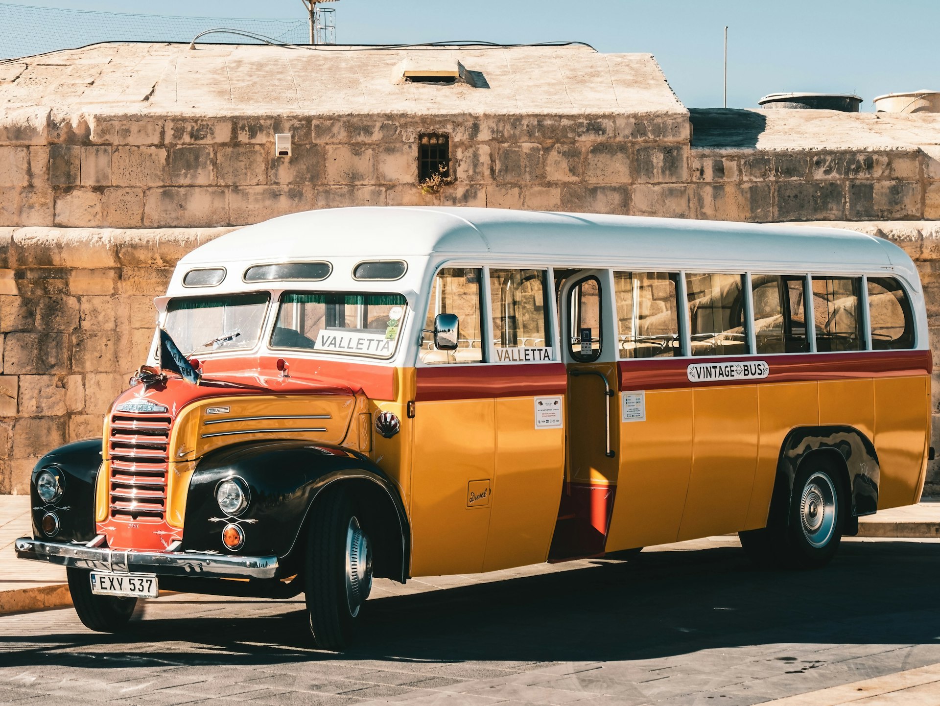 A vintage bus in the street in Valletta, Malta in the sunshine. 