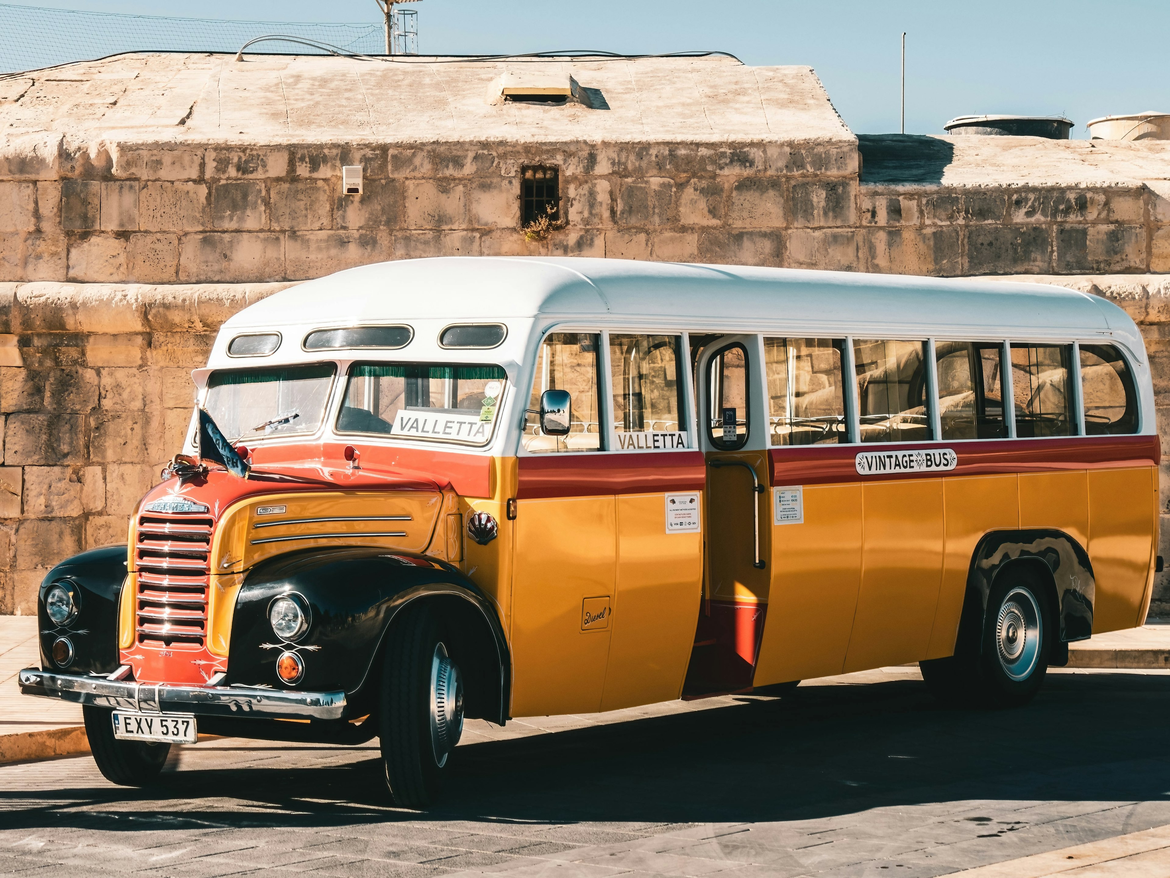 A vintage bus in the street in Valletta, Malta in the sunshine.