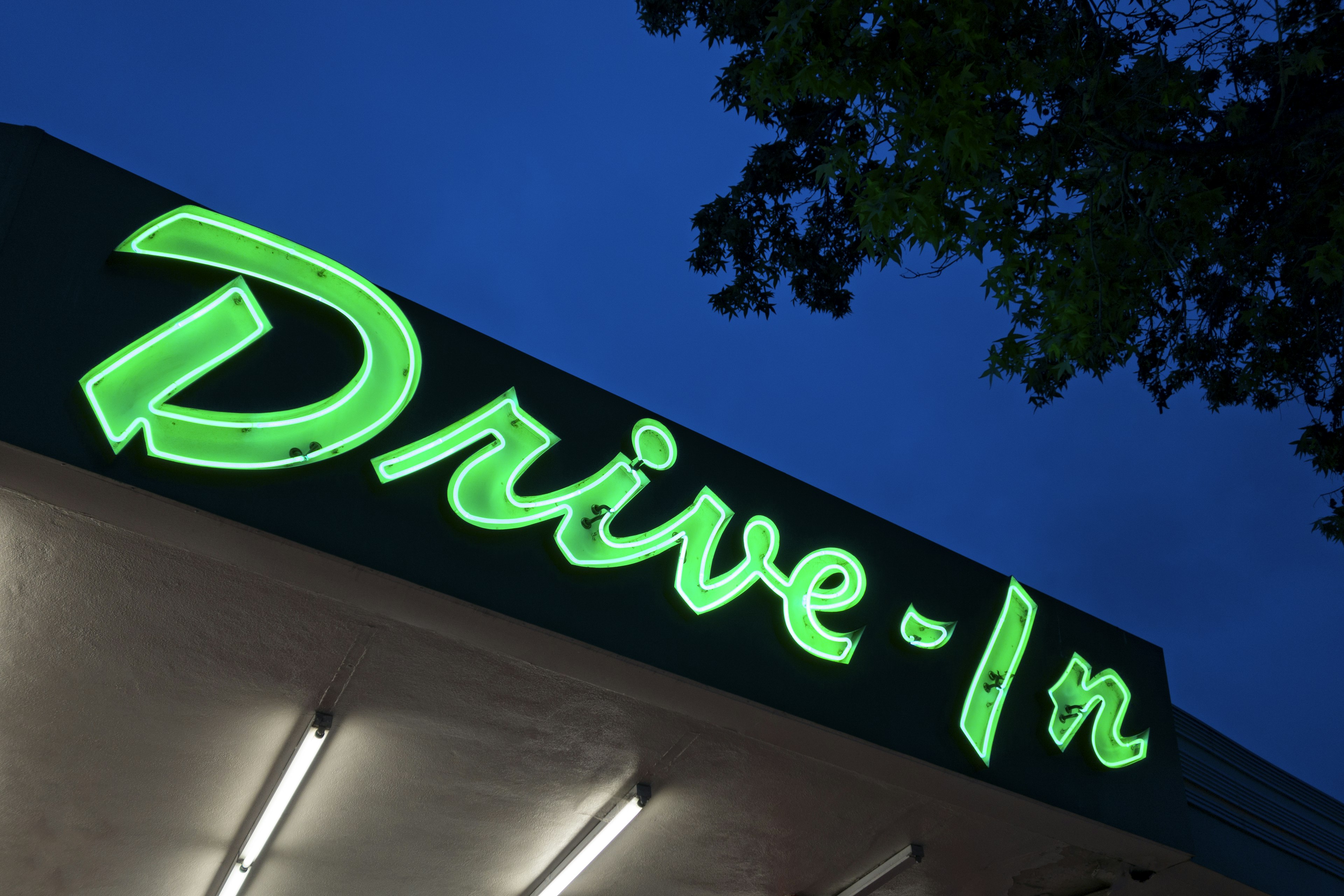 Neon drive in sign at dusk