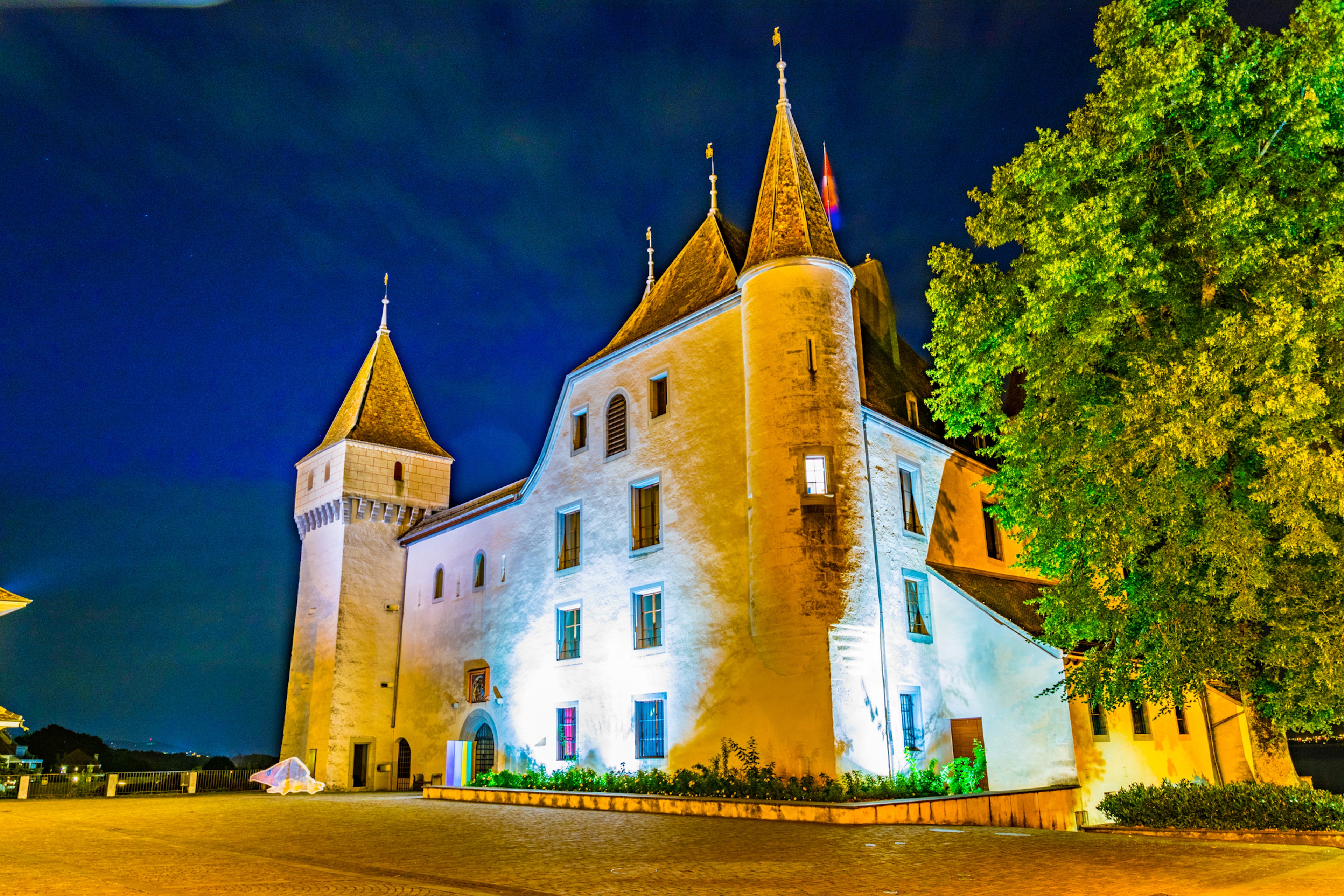 Night view of White Chateau de Nyon in Switzerland