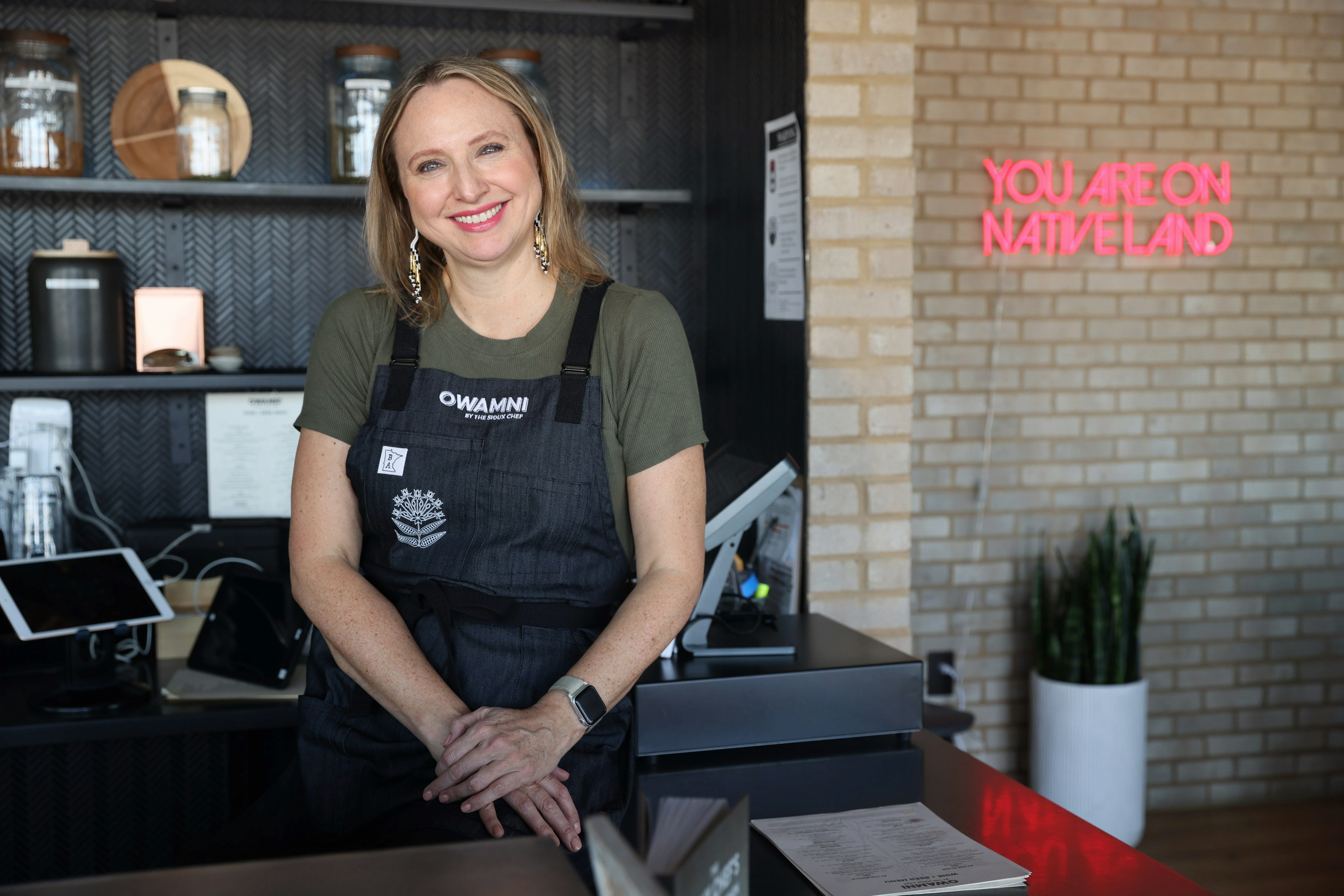 Dana Thompson at the hostess counter at Owamni