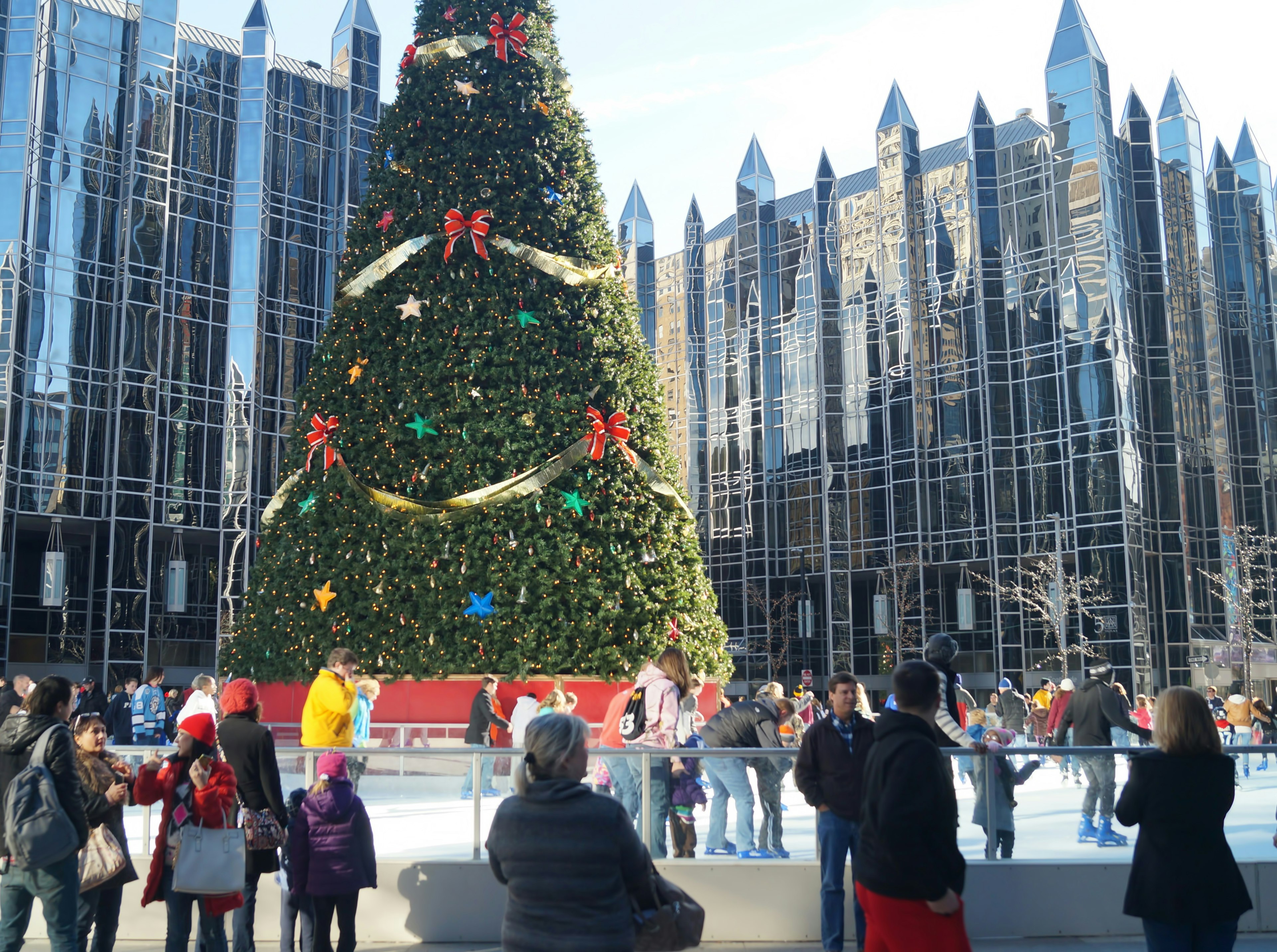 People ice skate and mull around the outdoor ice skating rink at PPG Place in downtown Pittsburgh.