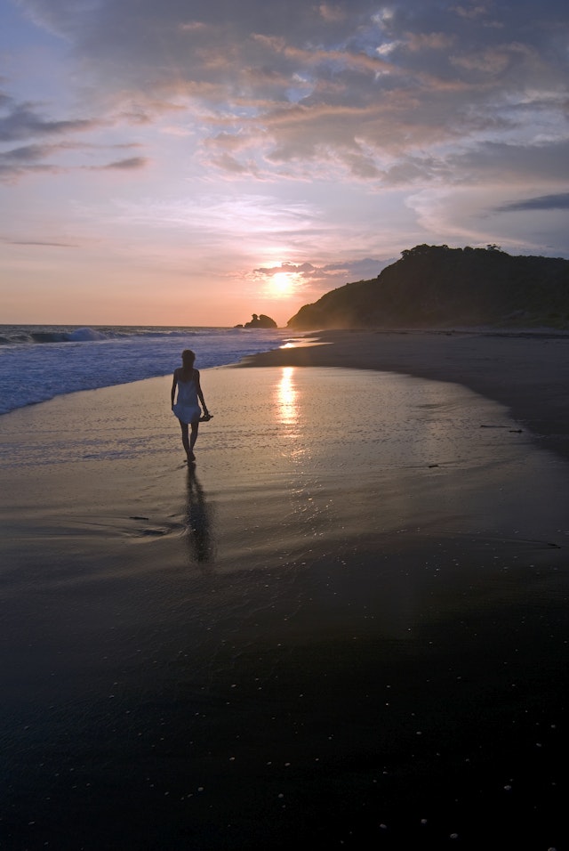 Young woman walking on beach