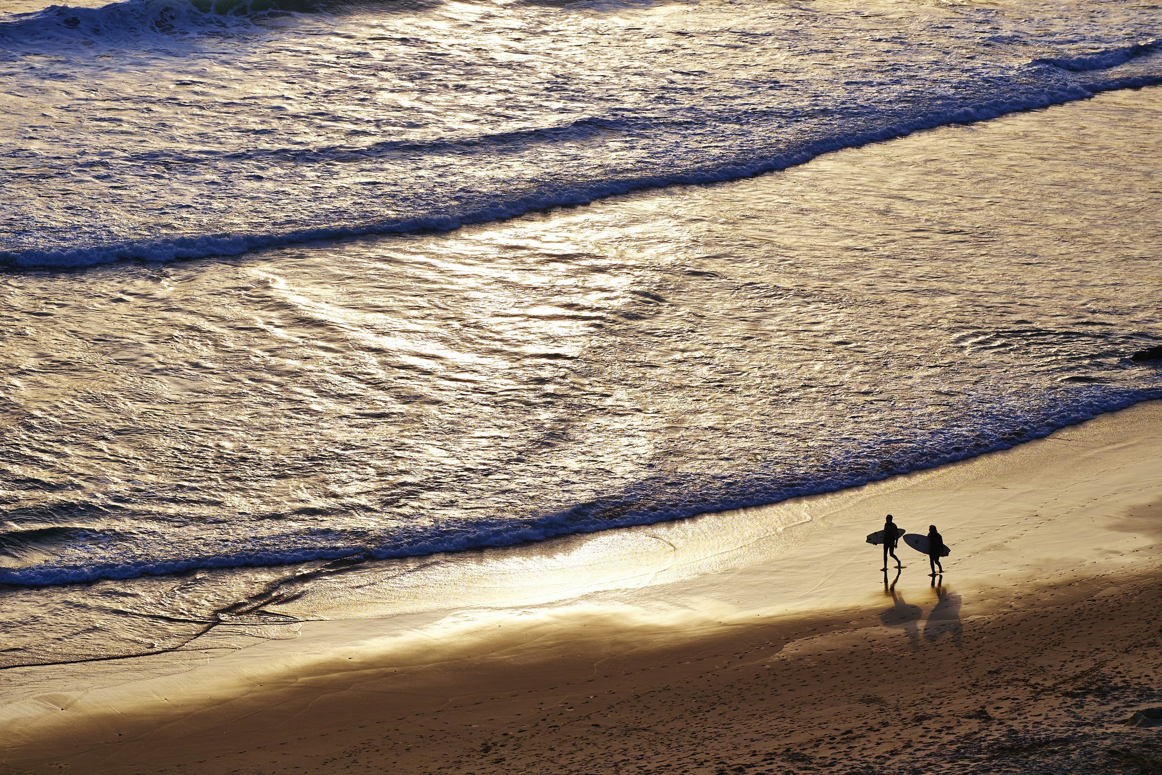 Surfers on the shore at Beliche beach, the Algarve