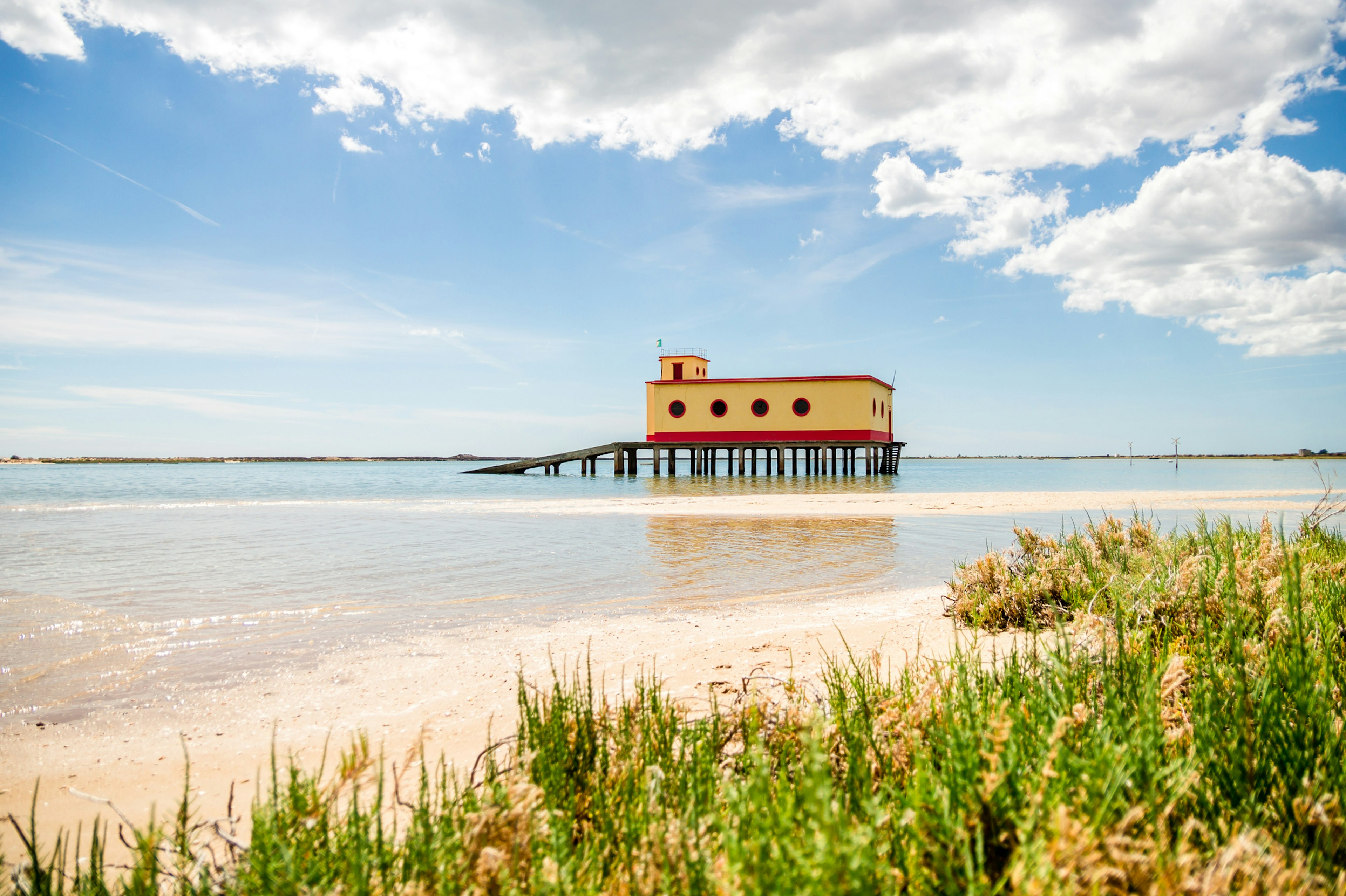 A life guard building with a ramp that leads directly into the ocean