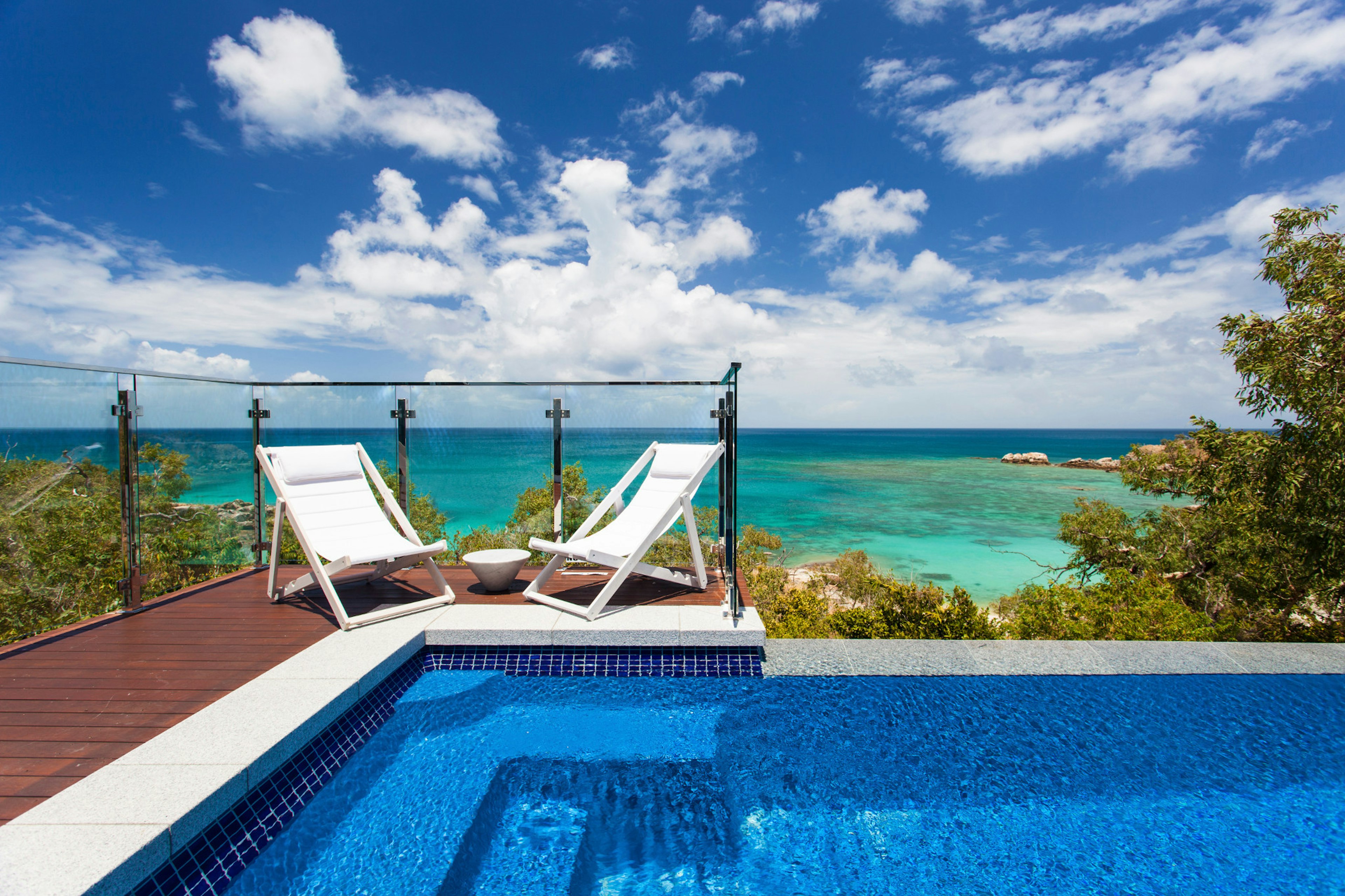 An infinity pool with sun loungers