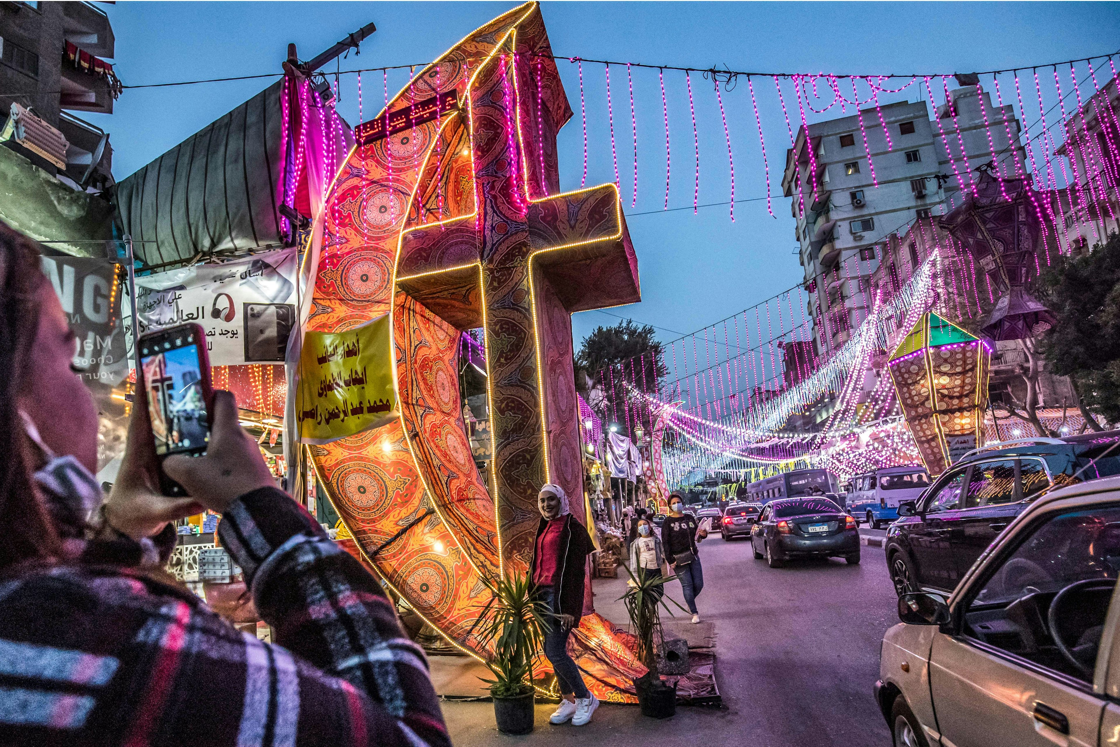 Light installations fill a street at night in the busy city of Cairo to celebrate Ramadan