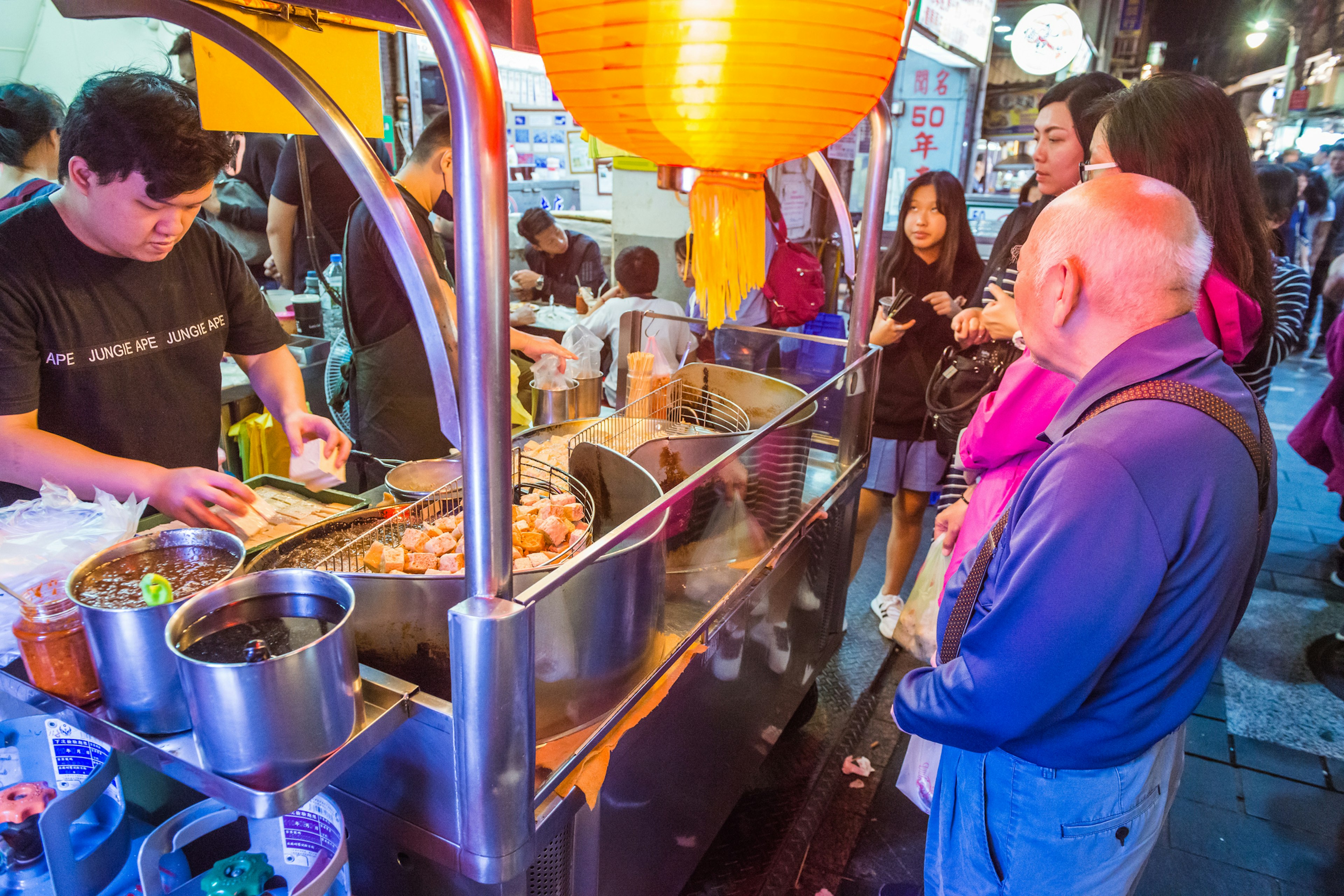 Taipei cook preparing bean curd snacks at a Raohe Street Night Market Stall