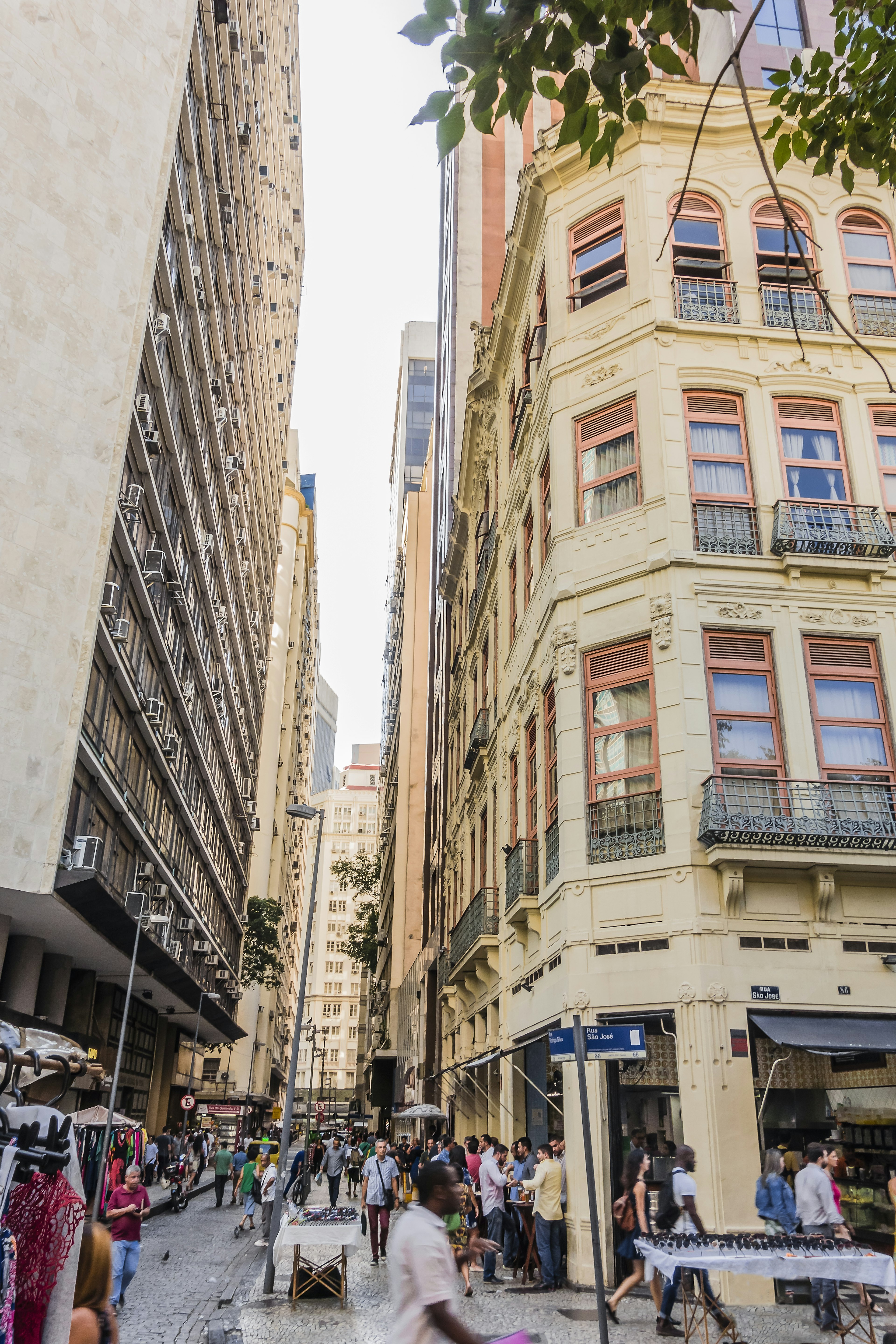 Narrow street between buildings in busy commercial district downtown Rio de Janeiro at lunch time