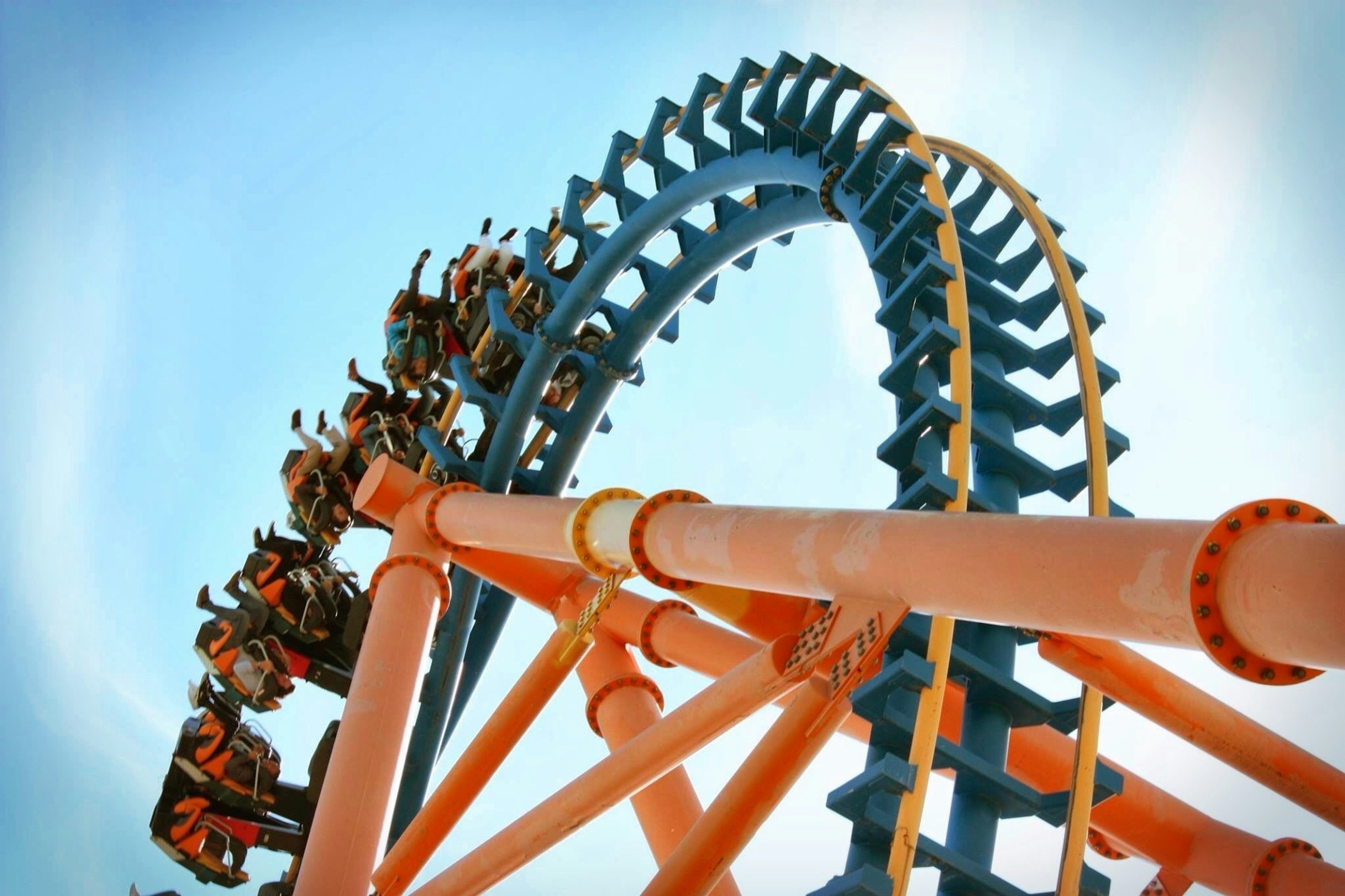 Low Angle View Of People Enjoying Rollercoaster Ride Against Sky