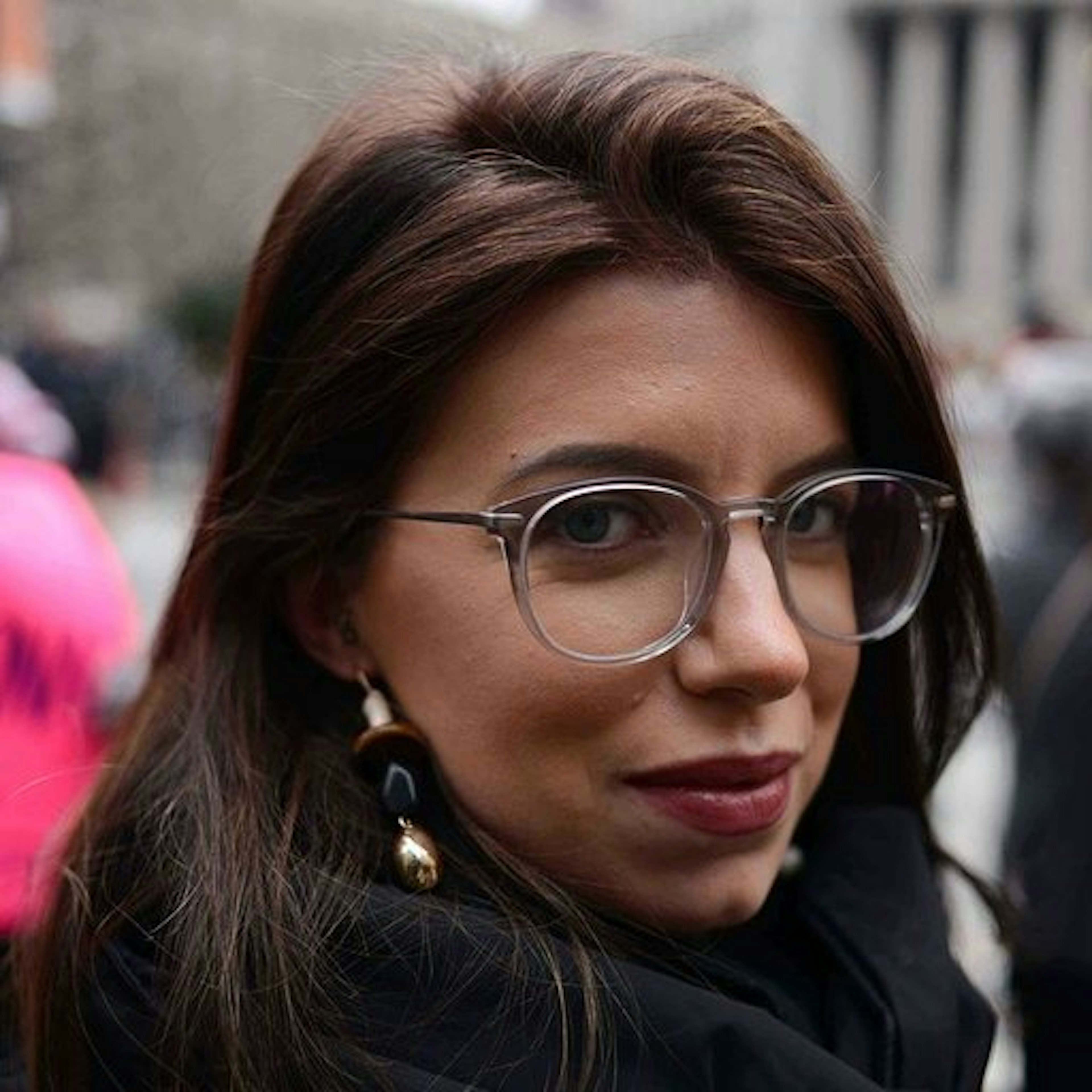 A close up portrait of Sasha Brady wearing glasses.