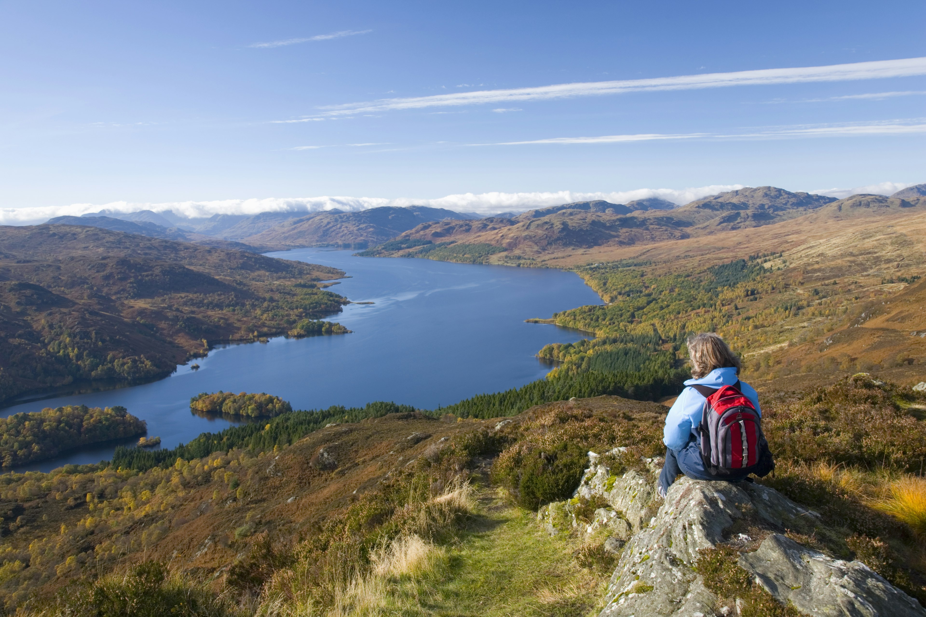 A hiker looking over Loch Katrine in Loch Lomond & the Trossachs National Park, Scotland