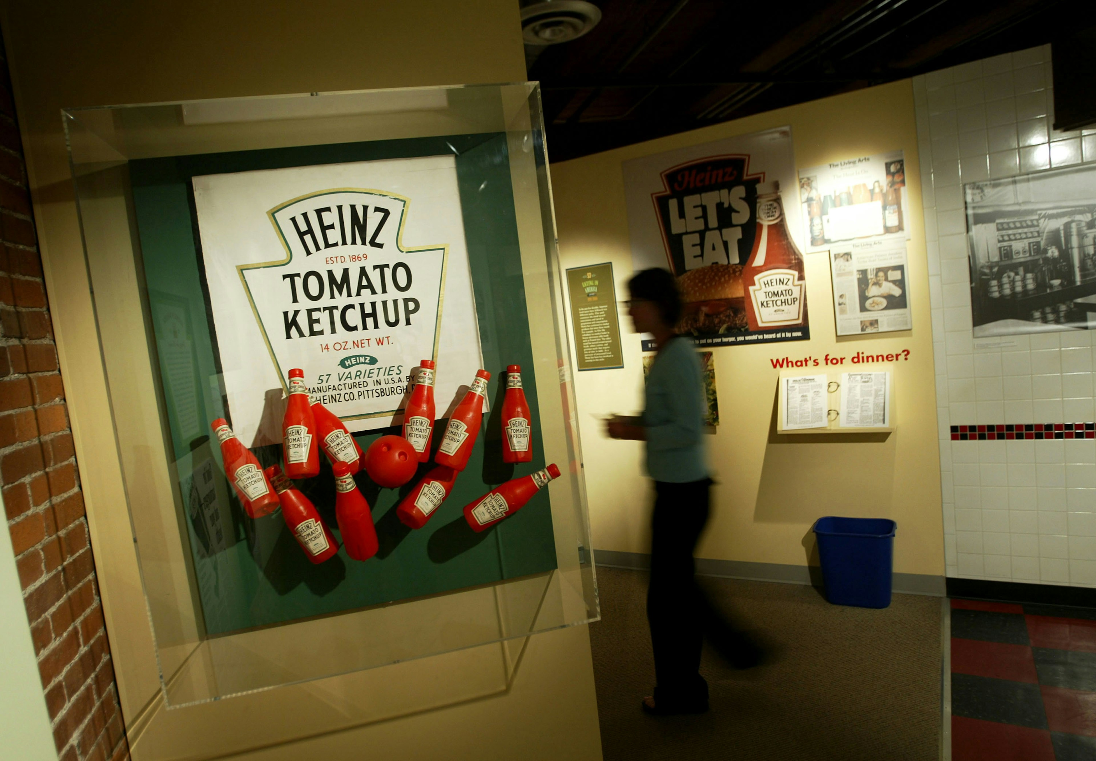 A woman walks through an exhibit showing the history of the Heinz corporation at the U.S. Senator John Heinz Pittsburgh Regional History Center