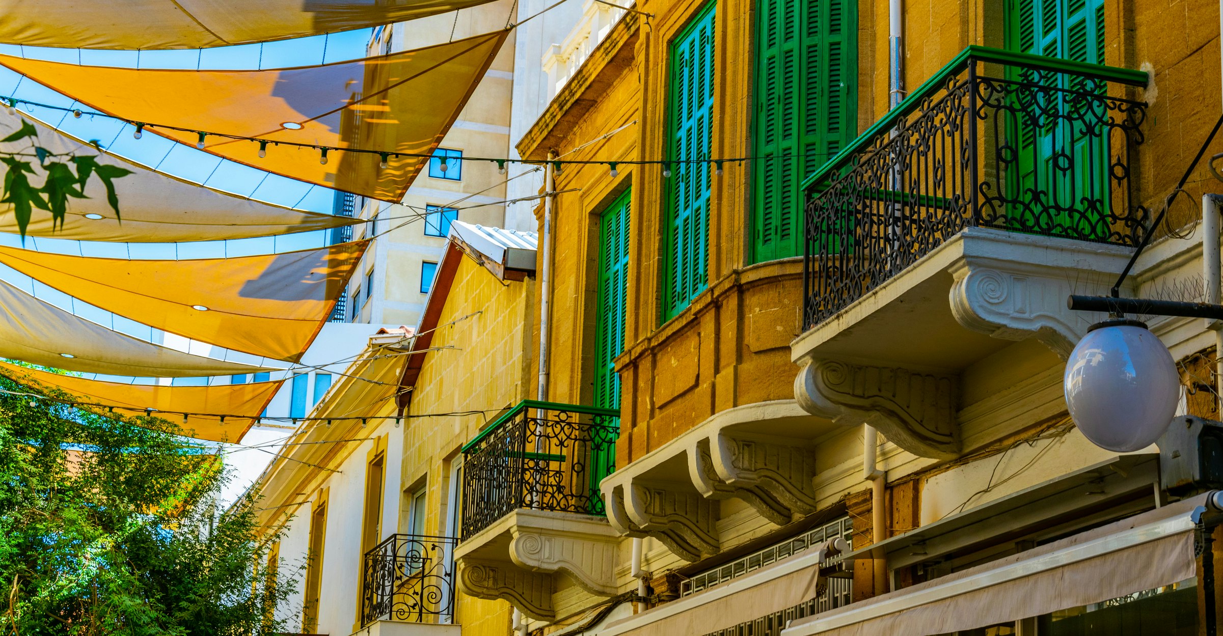 Colorful fabric is stretched across between the roofs of the main shopping avenue of Nicosia