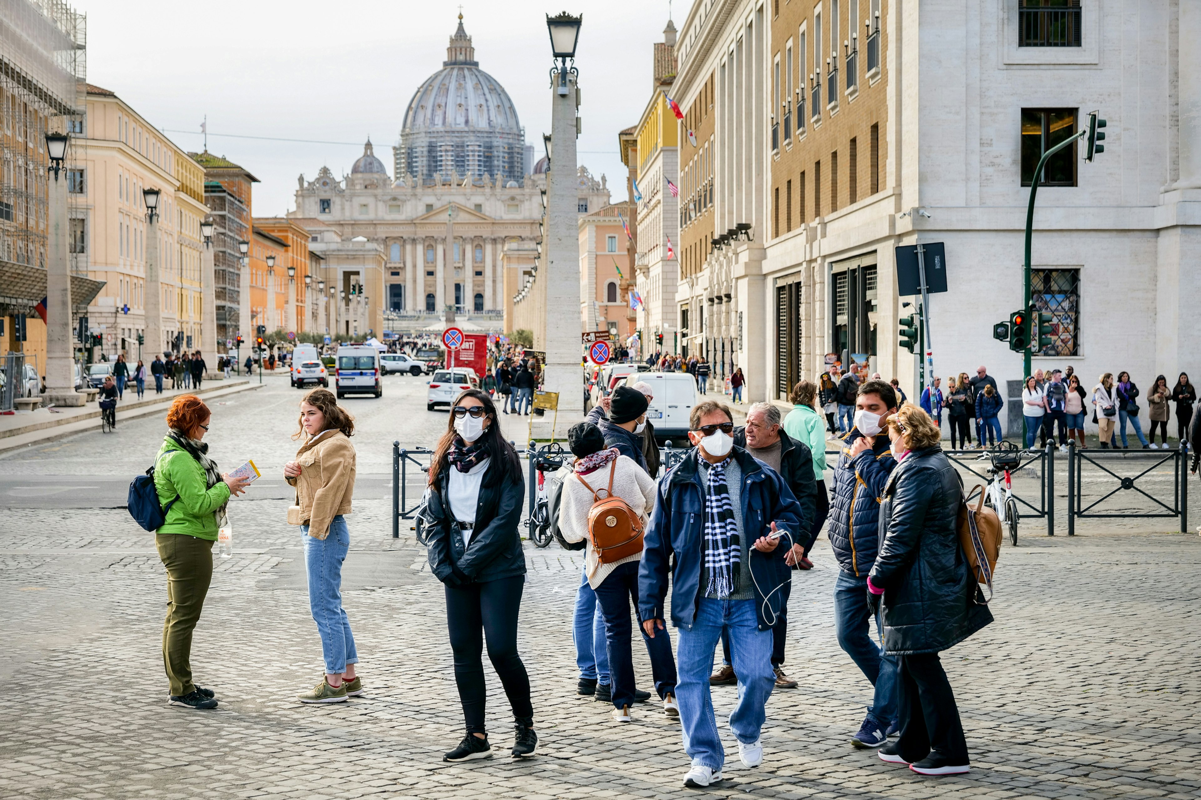 Some tourists visit the area of St. Peter's Basilica at the time of Covid-19